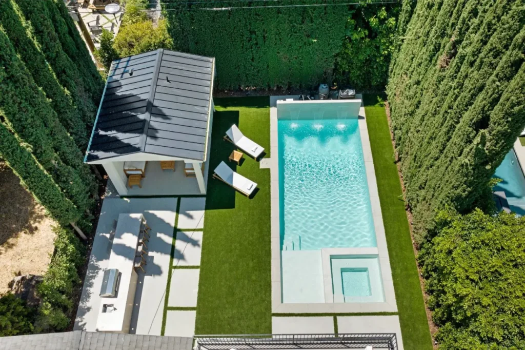 bird of view point of a home with a modern large pool and outdoor area