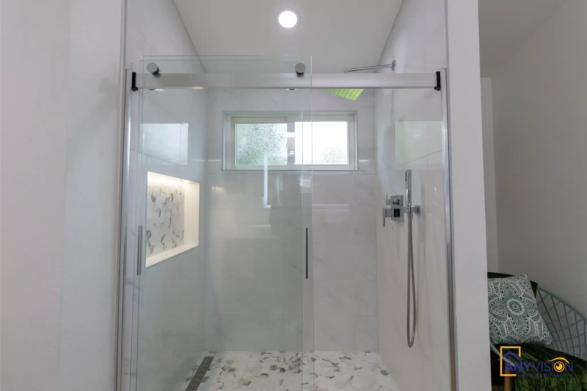 Frameless glass shower enclosure in the primary bath