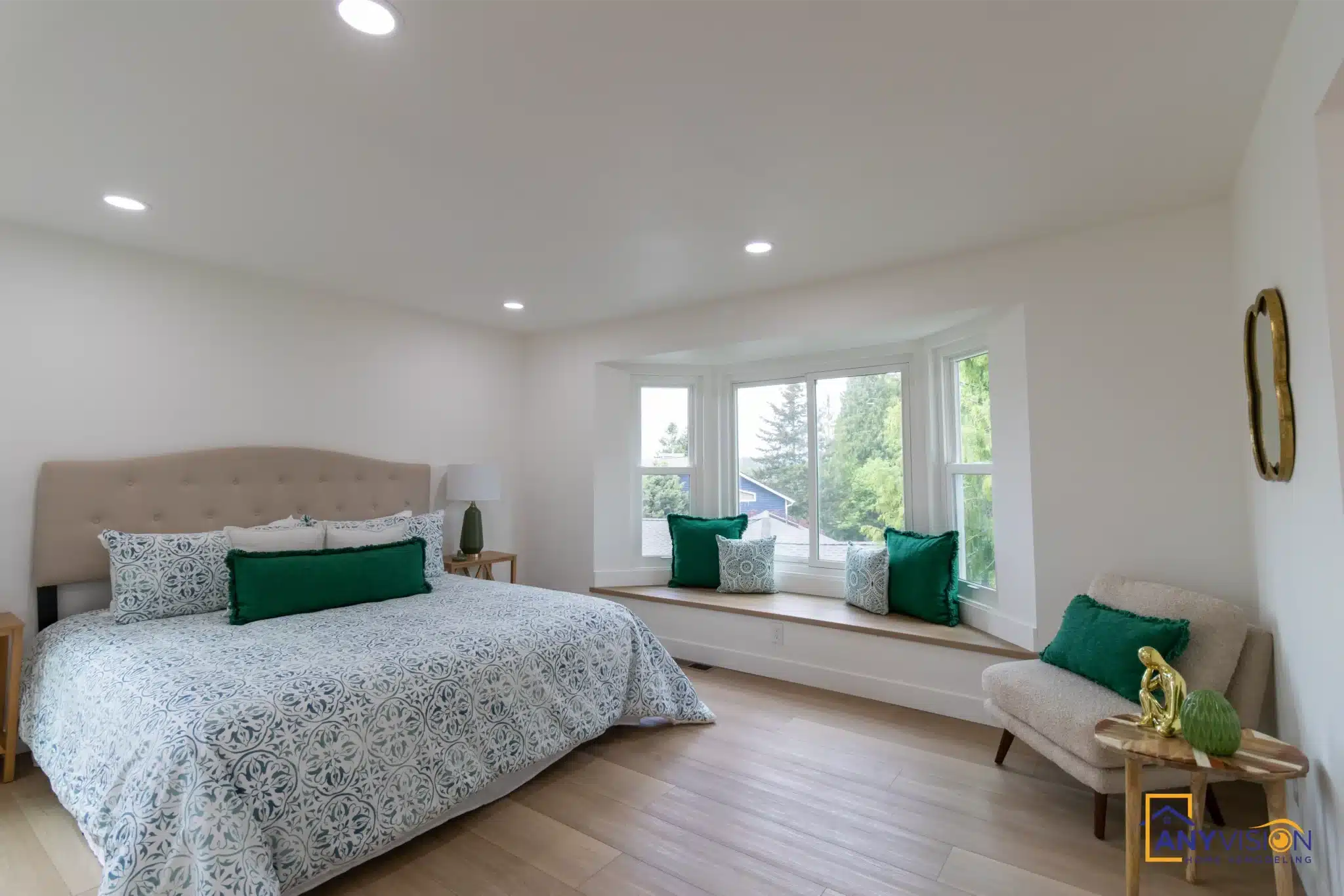 Bedroom with a built-in window seat and continuous plank flooring