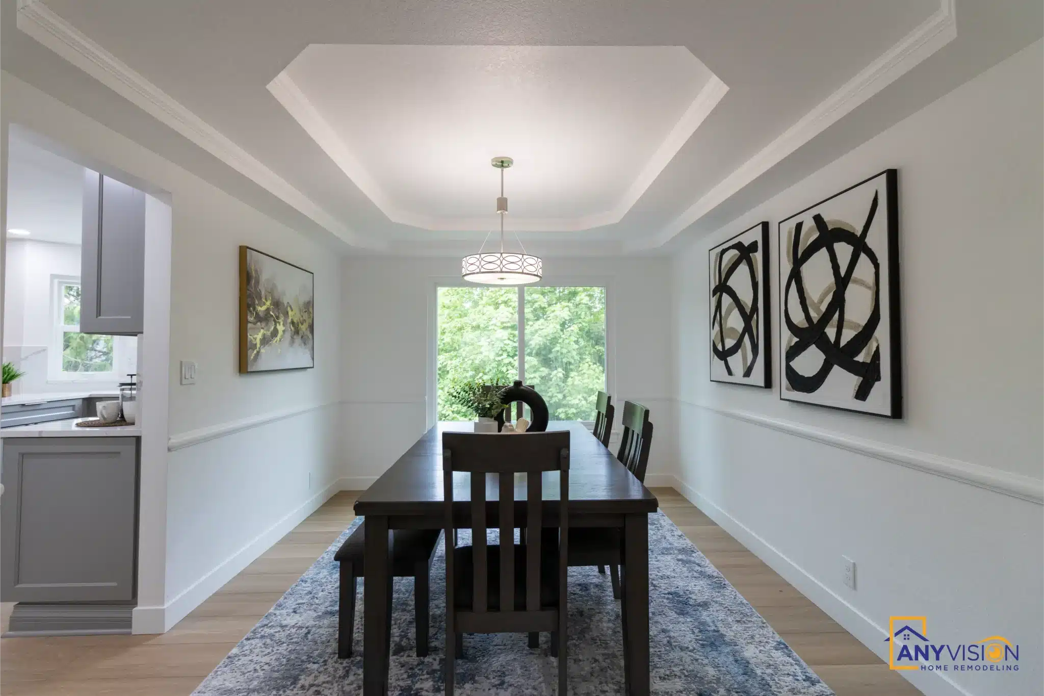Dining room with tray ceiling and pendant lighting
