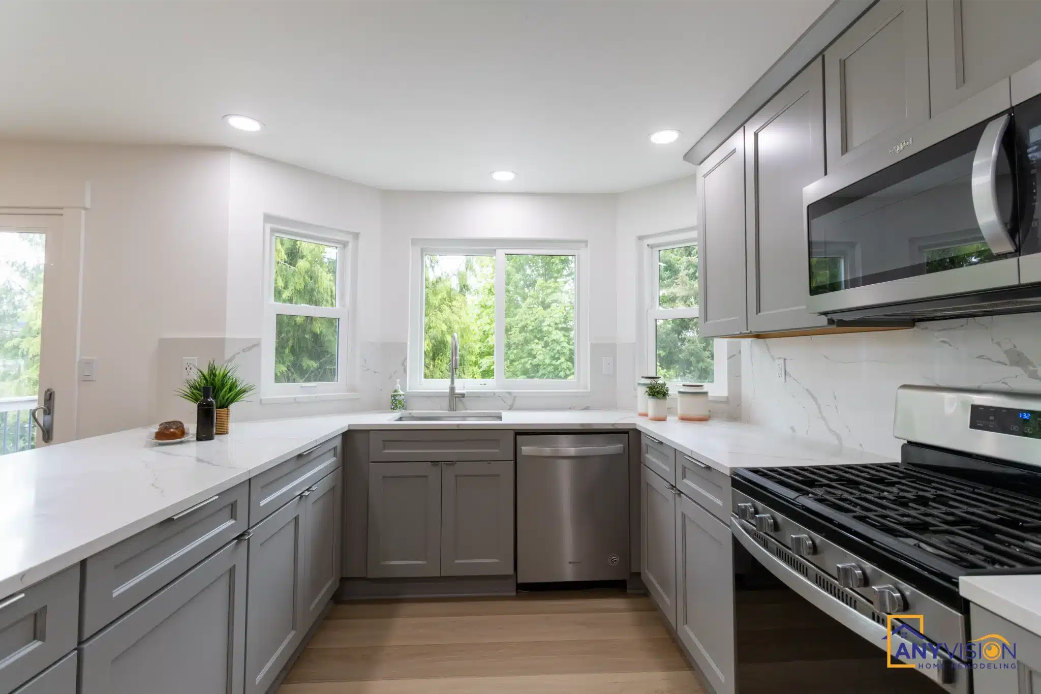 Kitchen with shaker cabinetry, quartz counters and a window over the sink