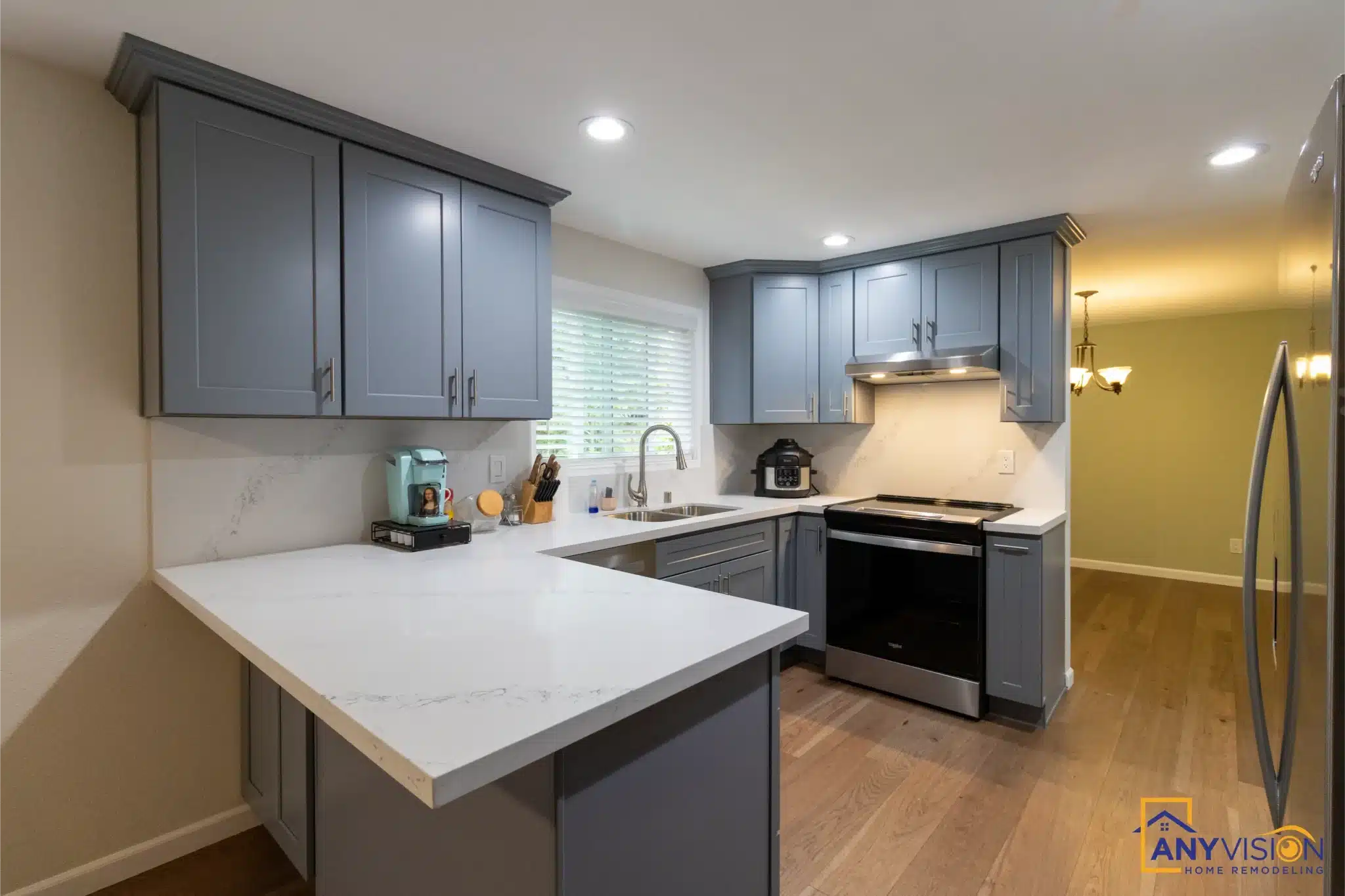 Kitchen peninsula and quartz counters in a completed Duvall remodel