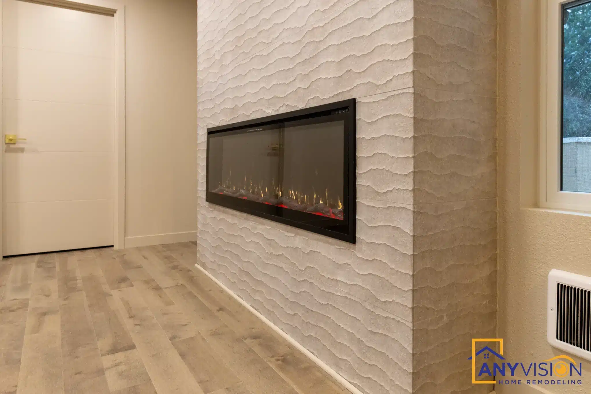Linear fireplace and tiled surround seen along the bedroom wall