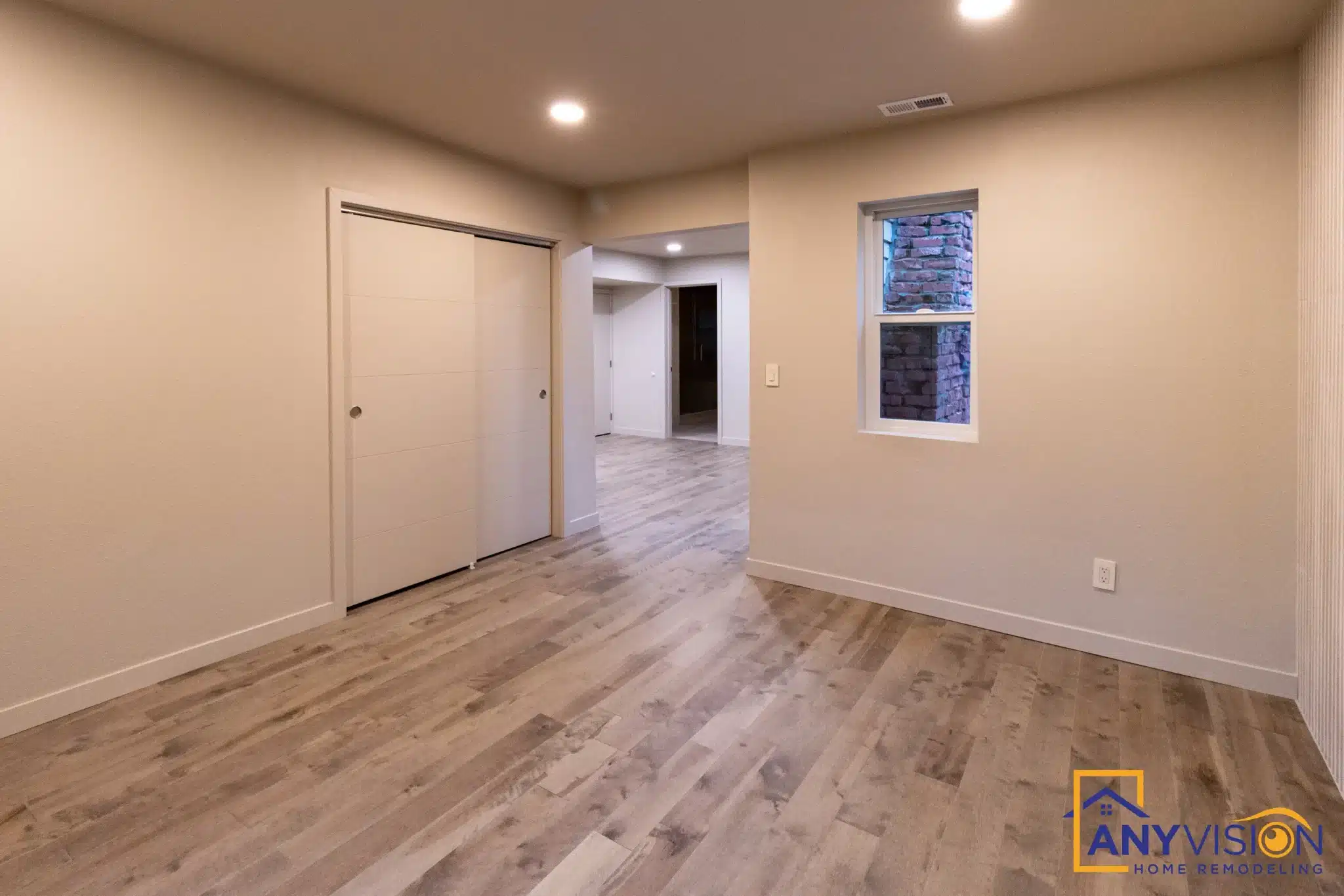 Bedroom with window and wide-plank oak flooring