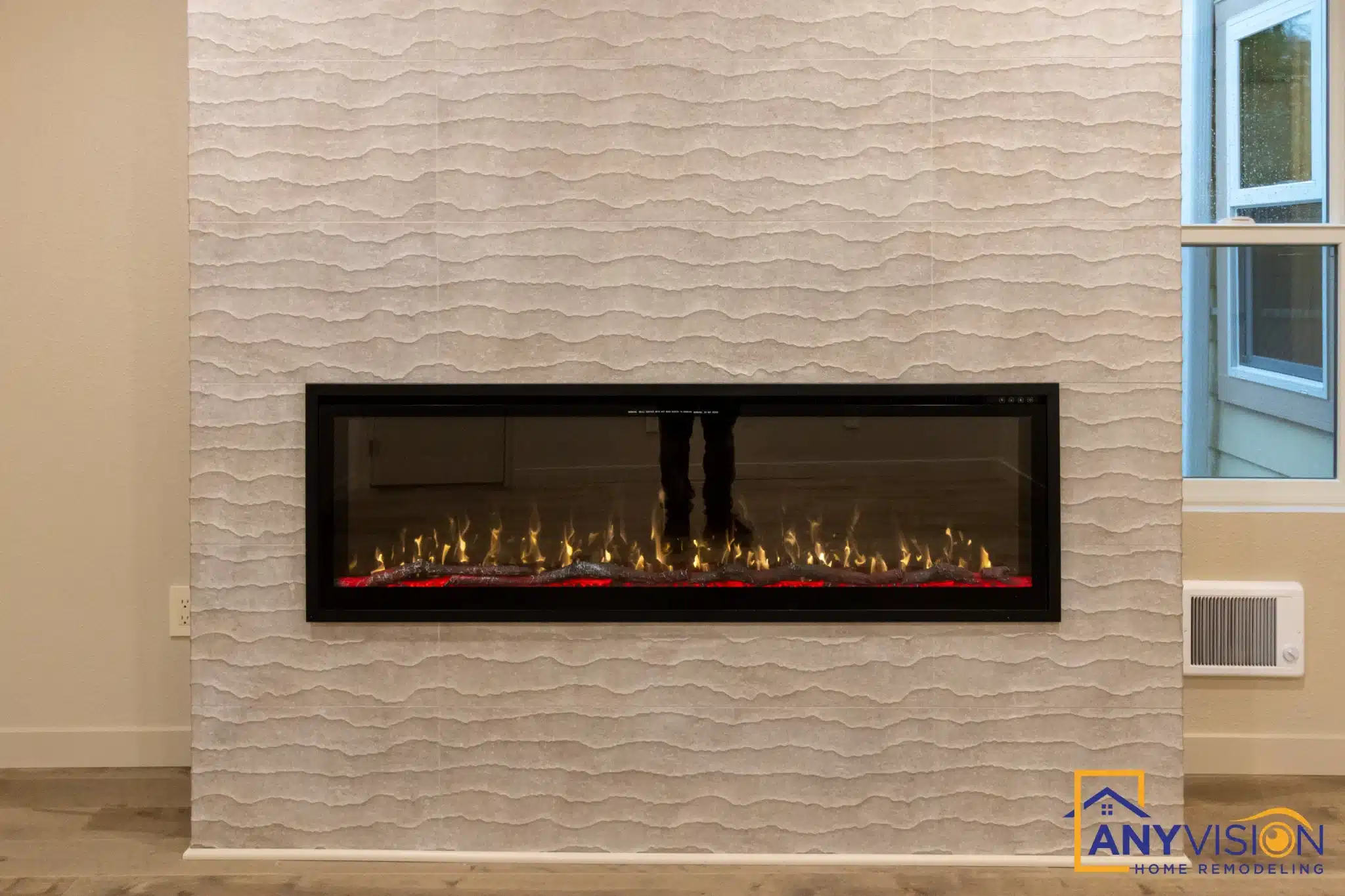 Linear electric fireplace set into a fluted tile surround
