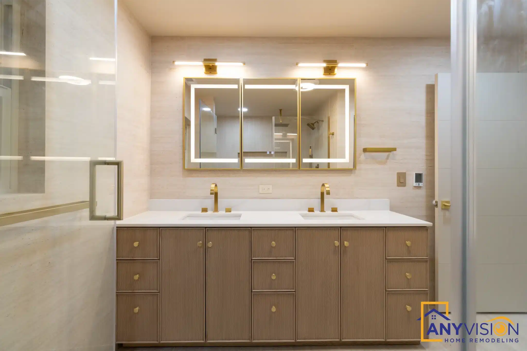 Double vanity with backlit mirrors and brushed gold tapware