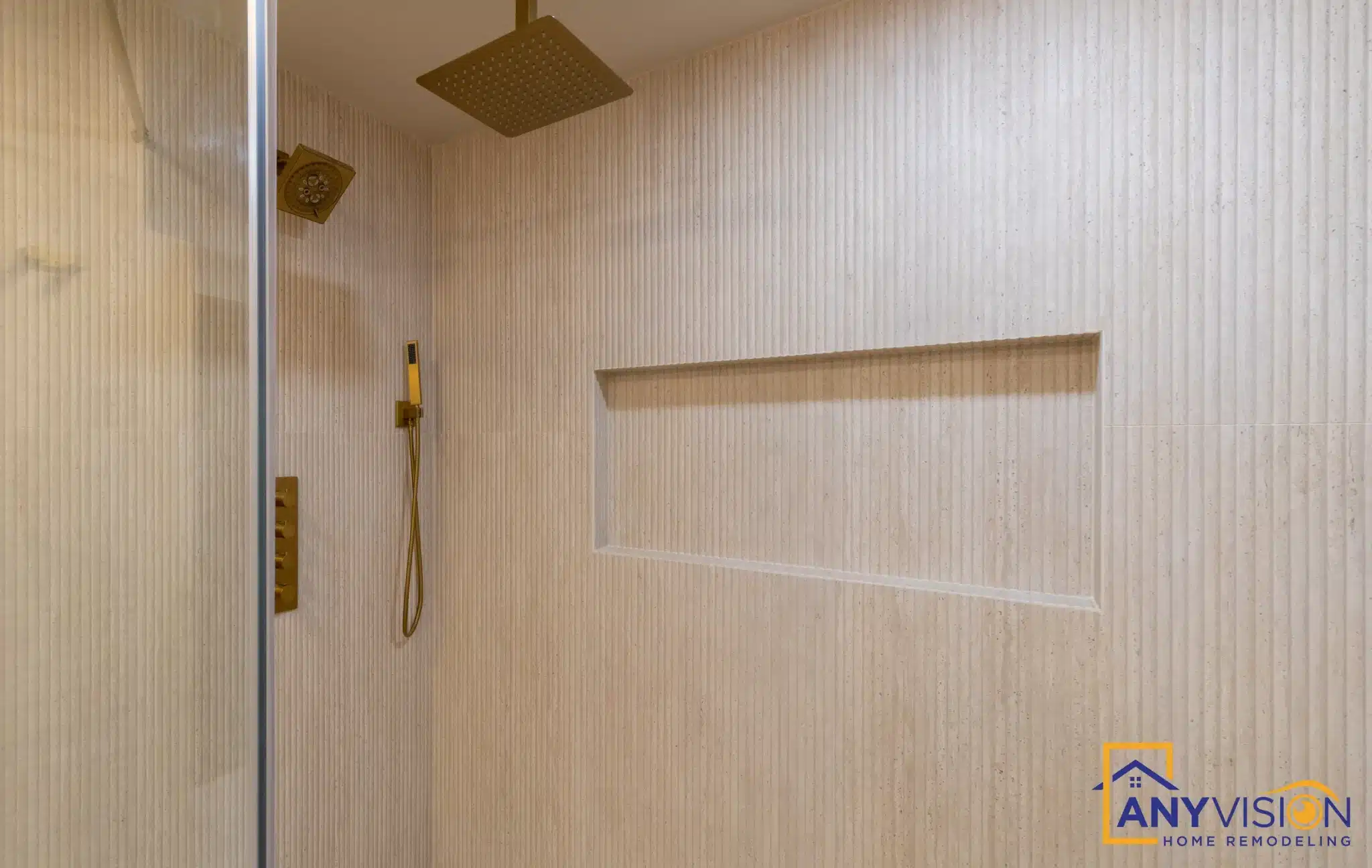 Glass-enclosed walk-in shower with rainfall head and recessed niche