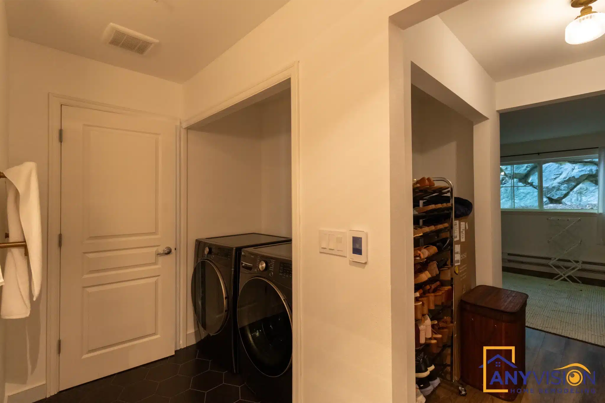 Hallway with stacked laundry in a compact Anyvision living space