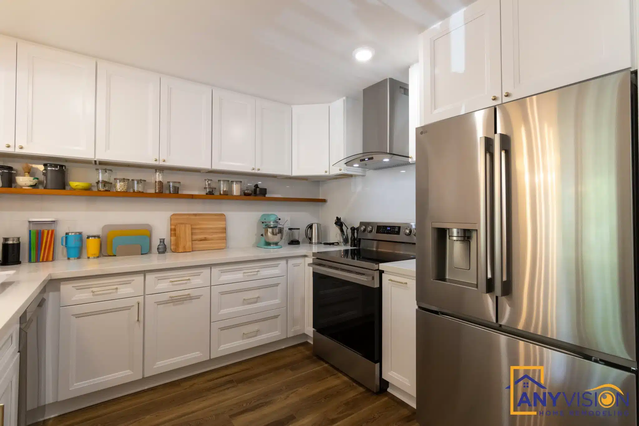 Condo kitchen with white cabinetry, open shelving and a stainless range