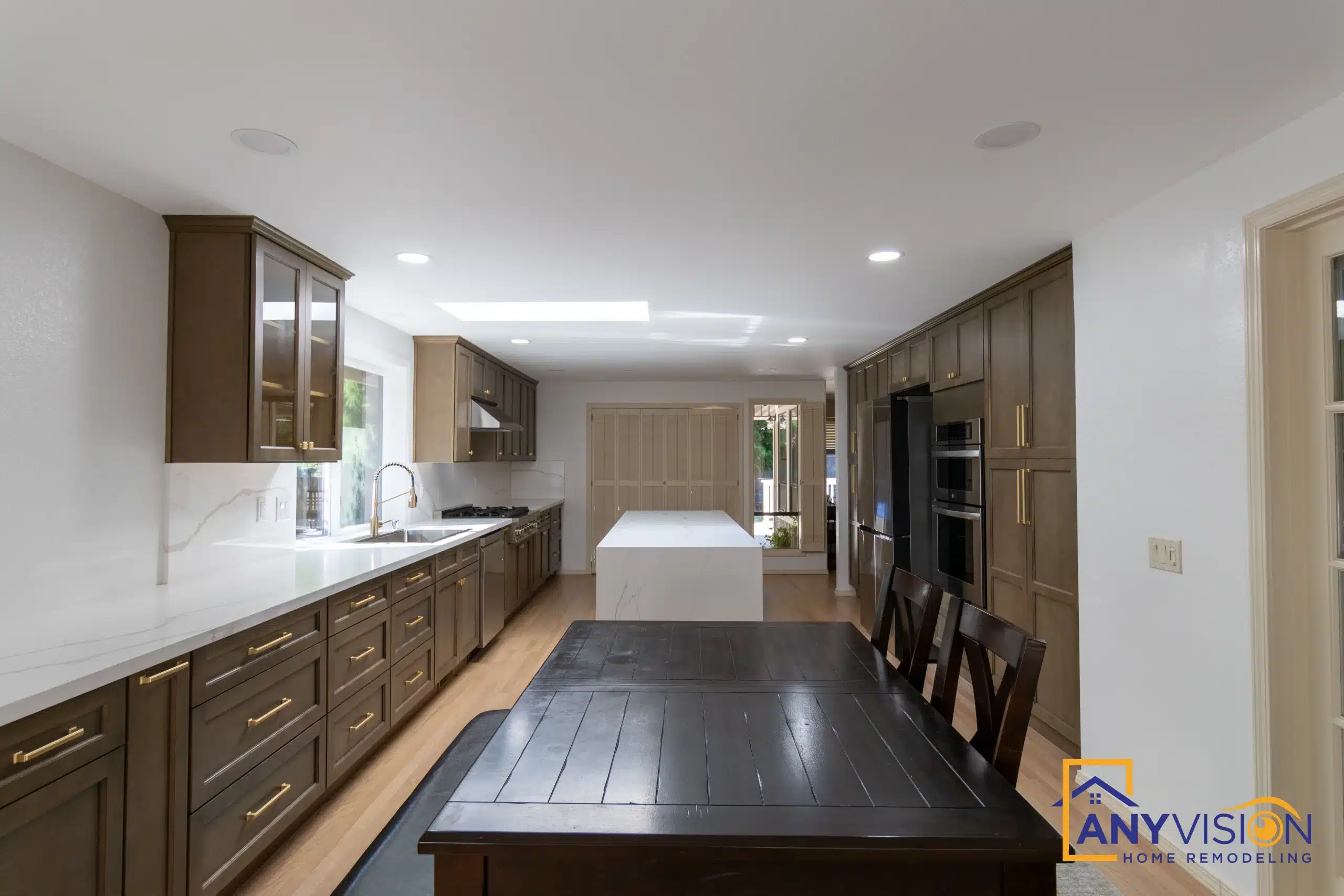 View down the kitchen showing the island run and dark hardwood flooring