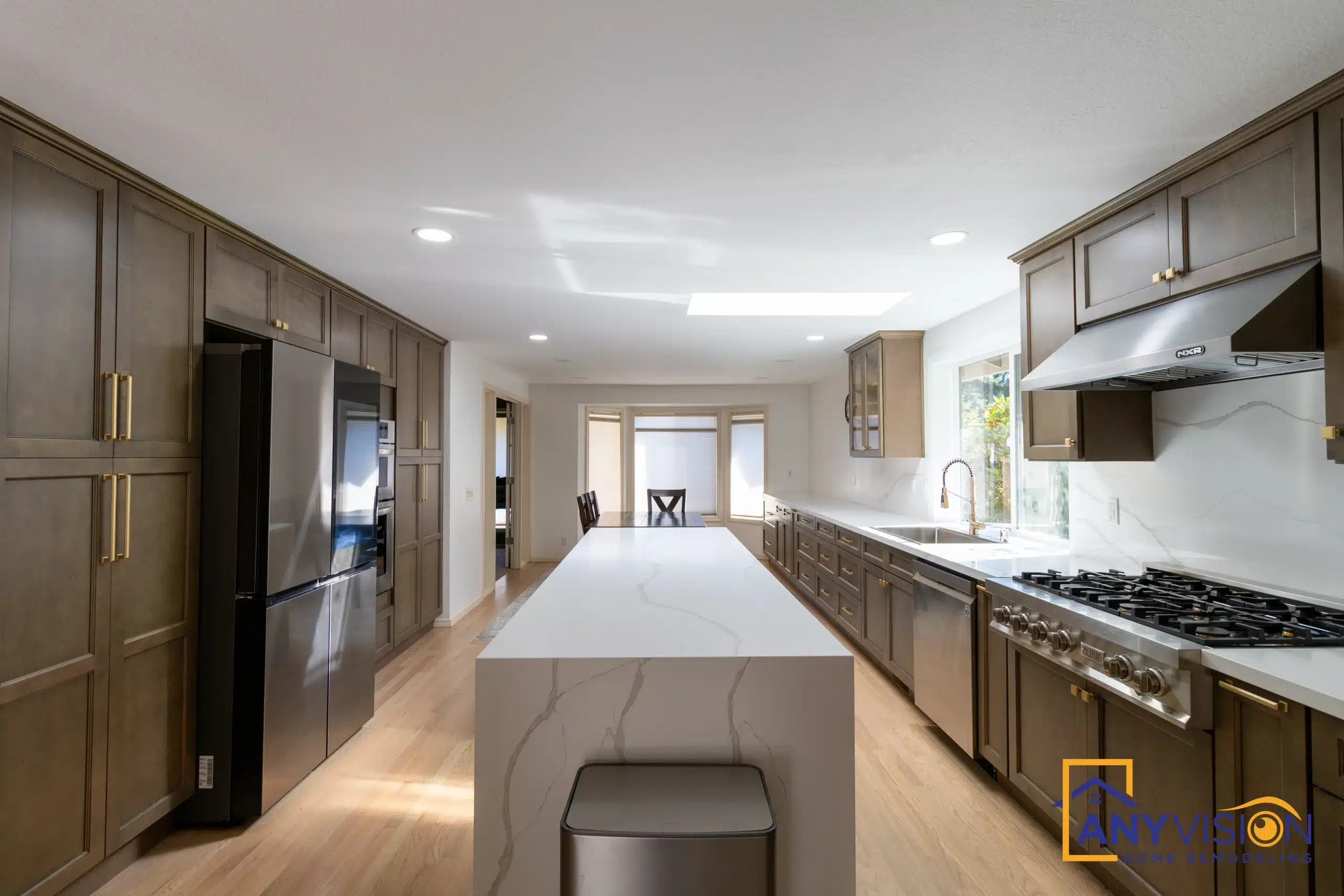 Remodelled kitchen with a quartz-topped island and walnut cabinetry by Anyvision