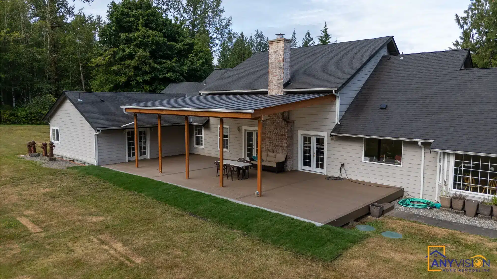 The covered deck seen from the far side of the lawn