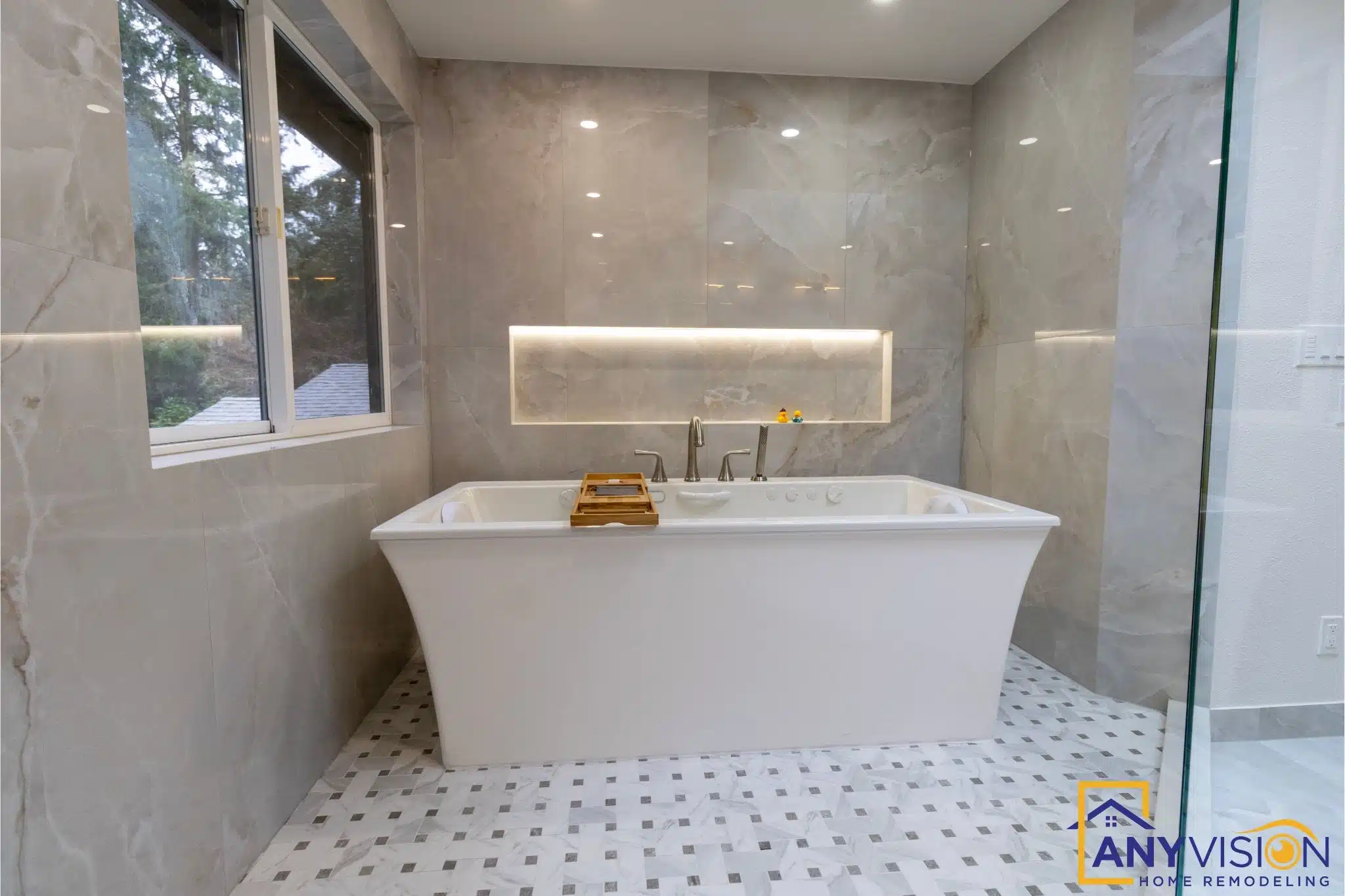 Freestanding soaking tub beneath a skylight in a Carnation, WA master bathroom by Anyvision