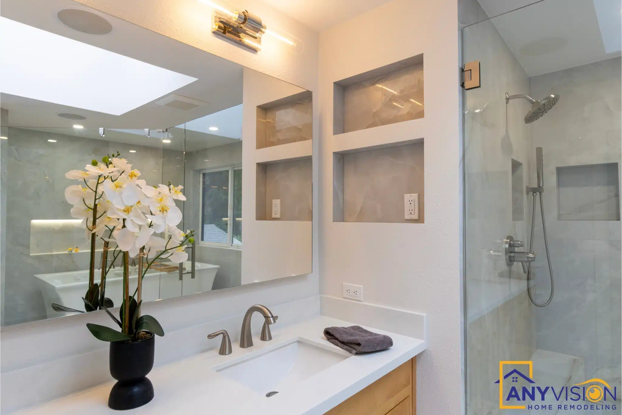 Vanity detail with brass fixtures and a recessed lit shelf