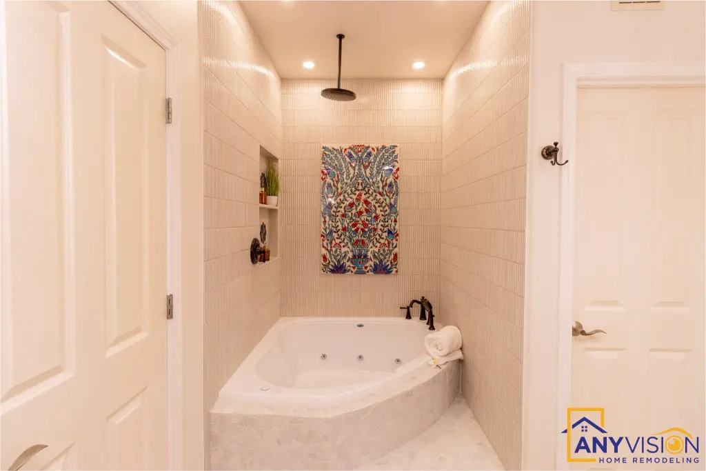 Corner soaking tub beneath a rainfall head, with the tile mural behind