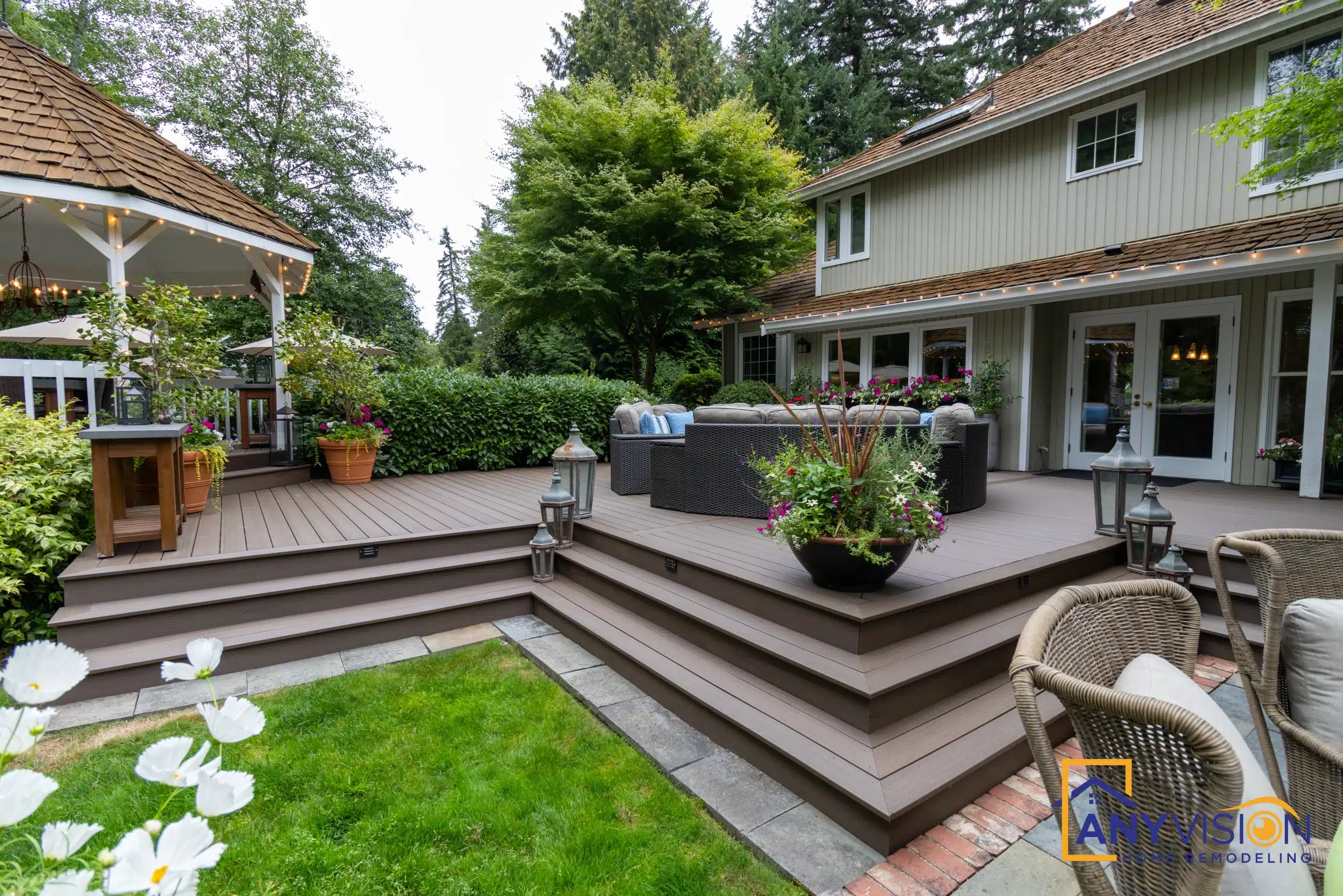 Wide deck stairs stepping down to the lawn with planting alongside