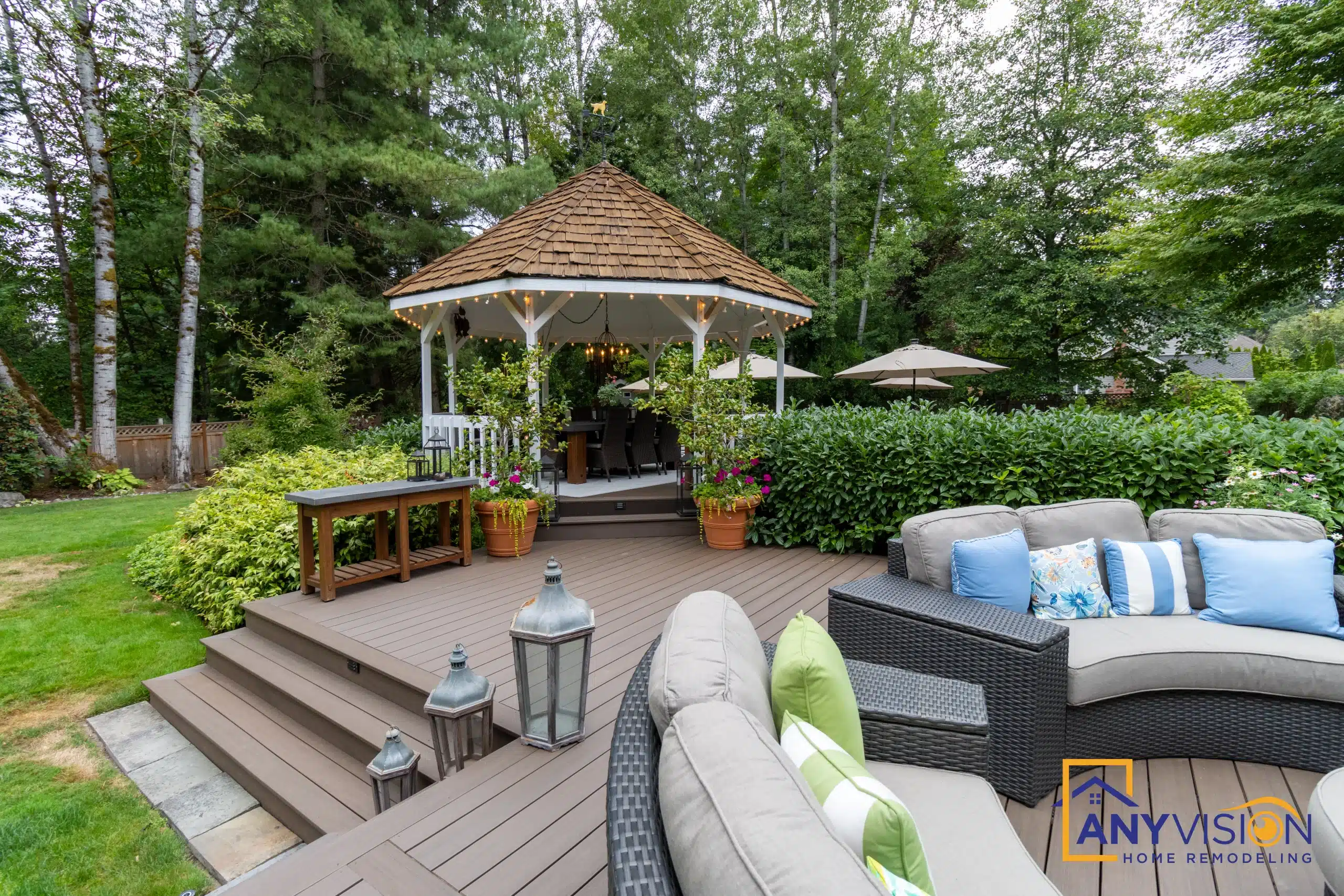 Shingled gazebo with lounge seating and planters on the upper deck level