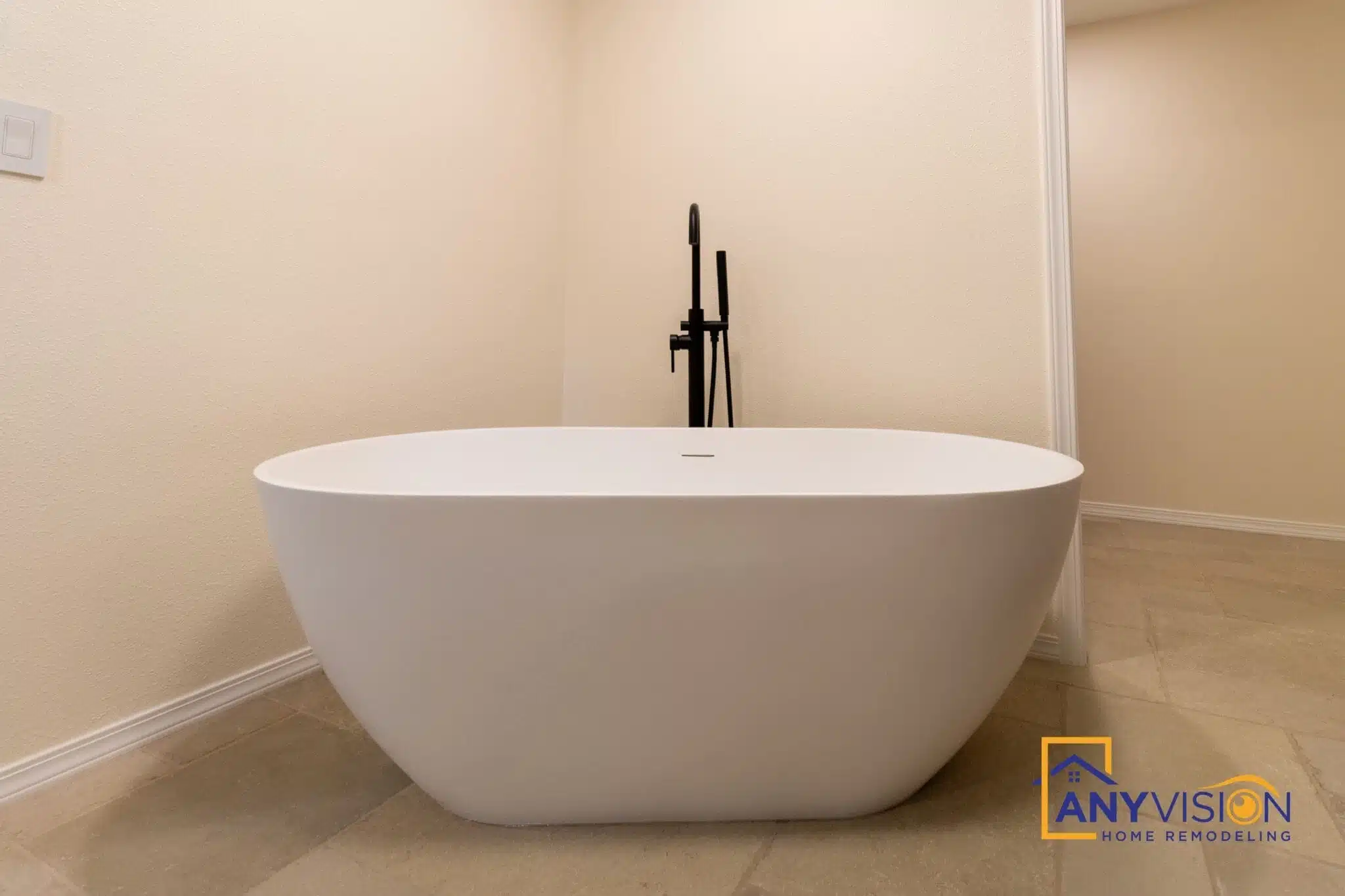 Freestanding tub with a floor-mounted matte black filler