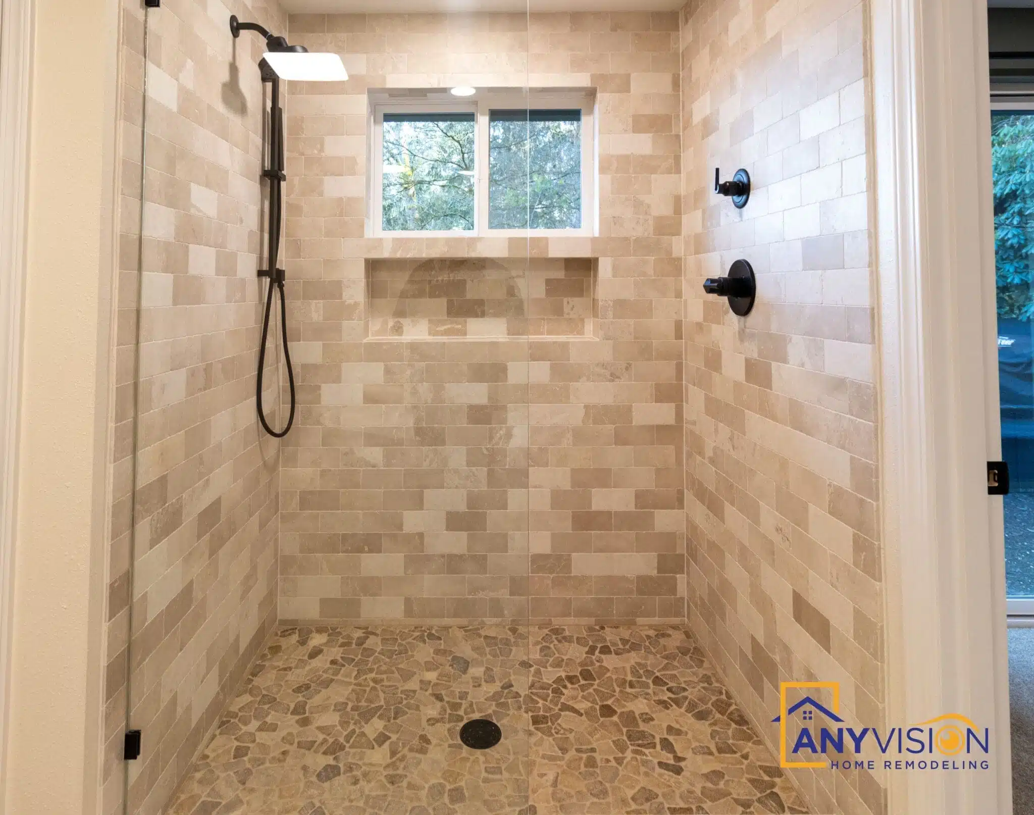 Glass-enclosed walk-in shower with a tiled bench and window