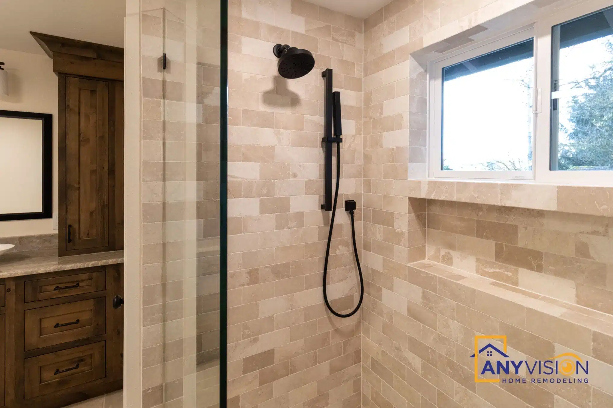 Walk-in shower with matte black fixtures and full-height tile