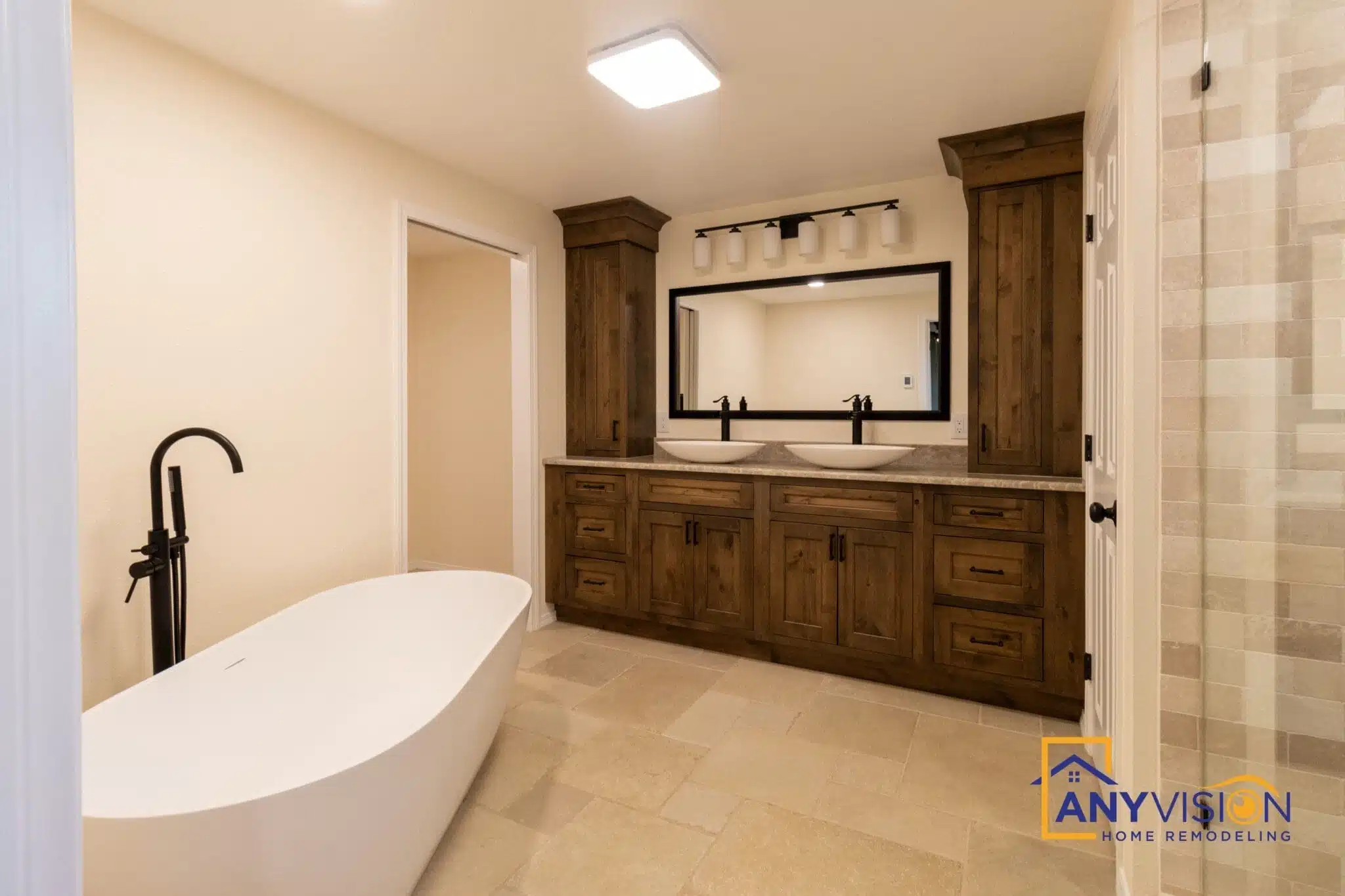 Ensuite bathroom with freestanding tub beside a dark wood vanity