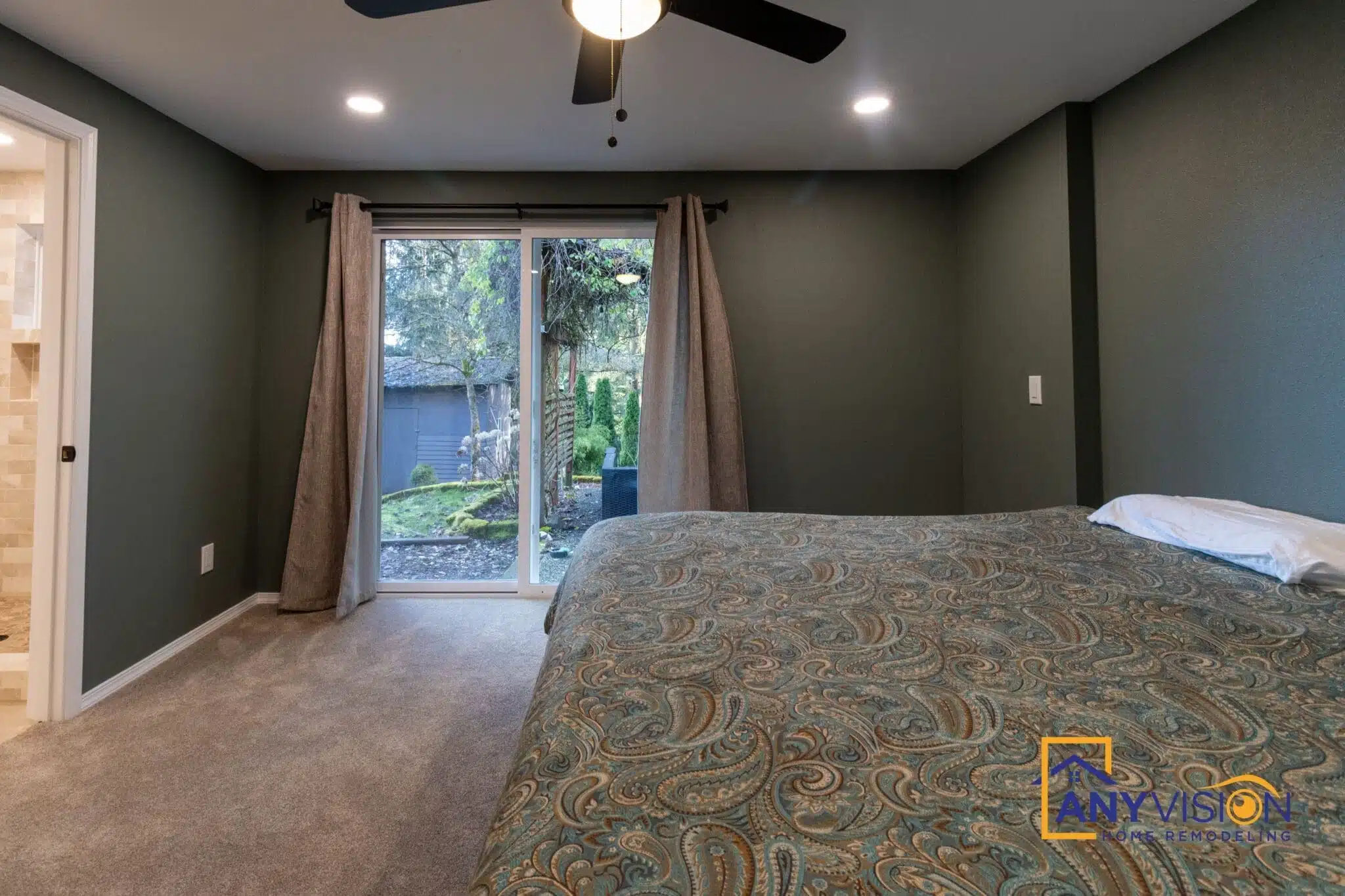 New primary bedroom with a sliding door opening onto the deck, added by Anyvision in Woodinville