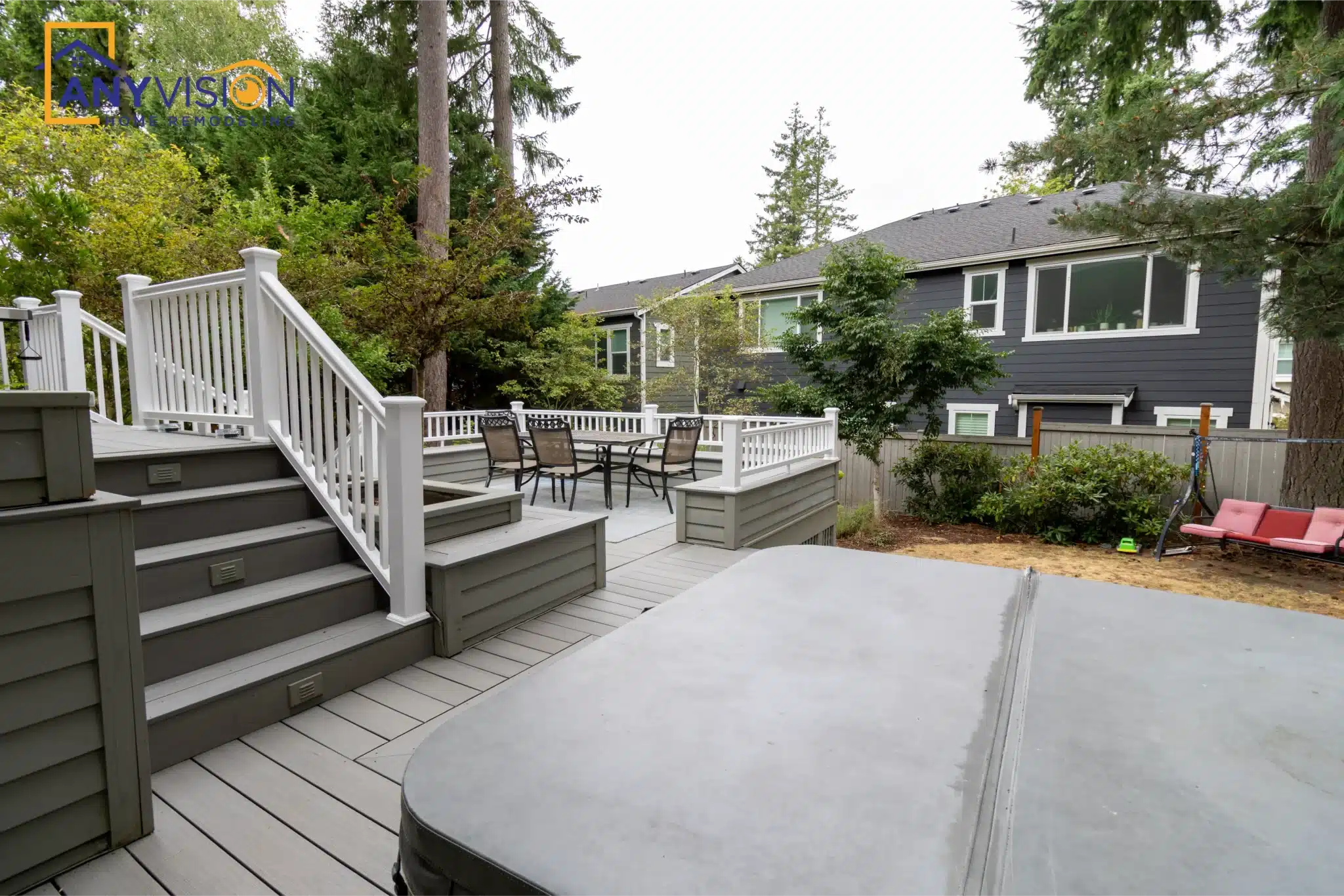 Multi-level composite deck with white railings and wide stairs, Issaquah
