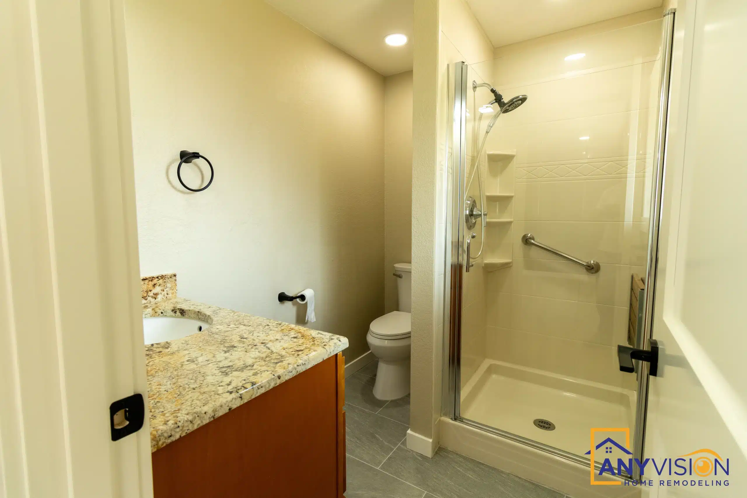Second bathroom with a walk-in shower and stone-topped vanity