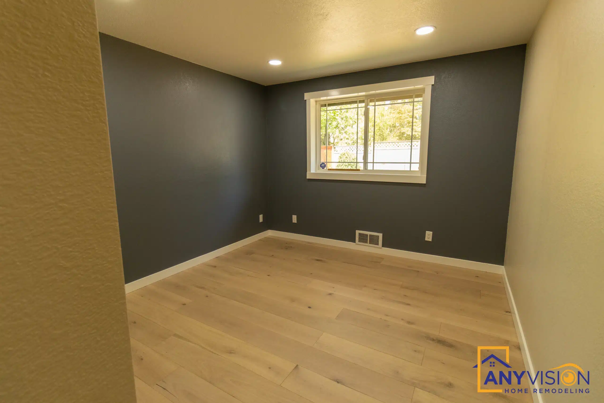 Bedroom finished with a dark accent wall and new casing