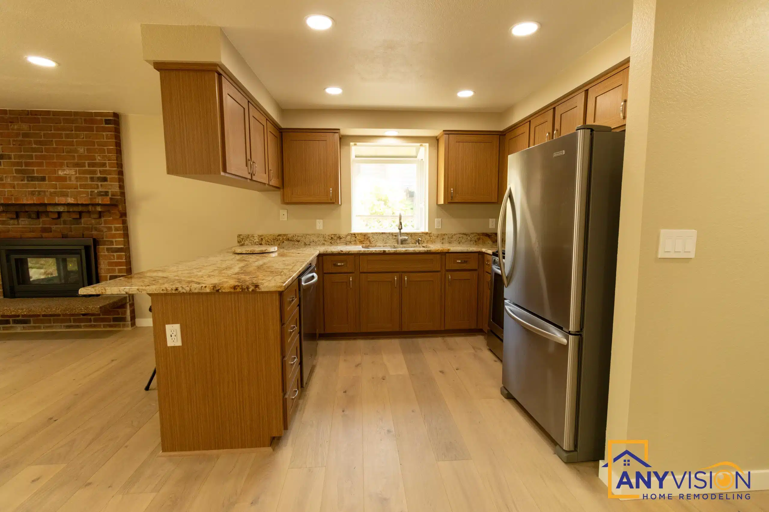 Rebuilt kitchen with full-height cabinetry and a stainless refrigerator