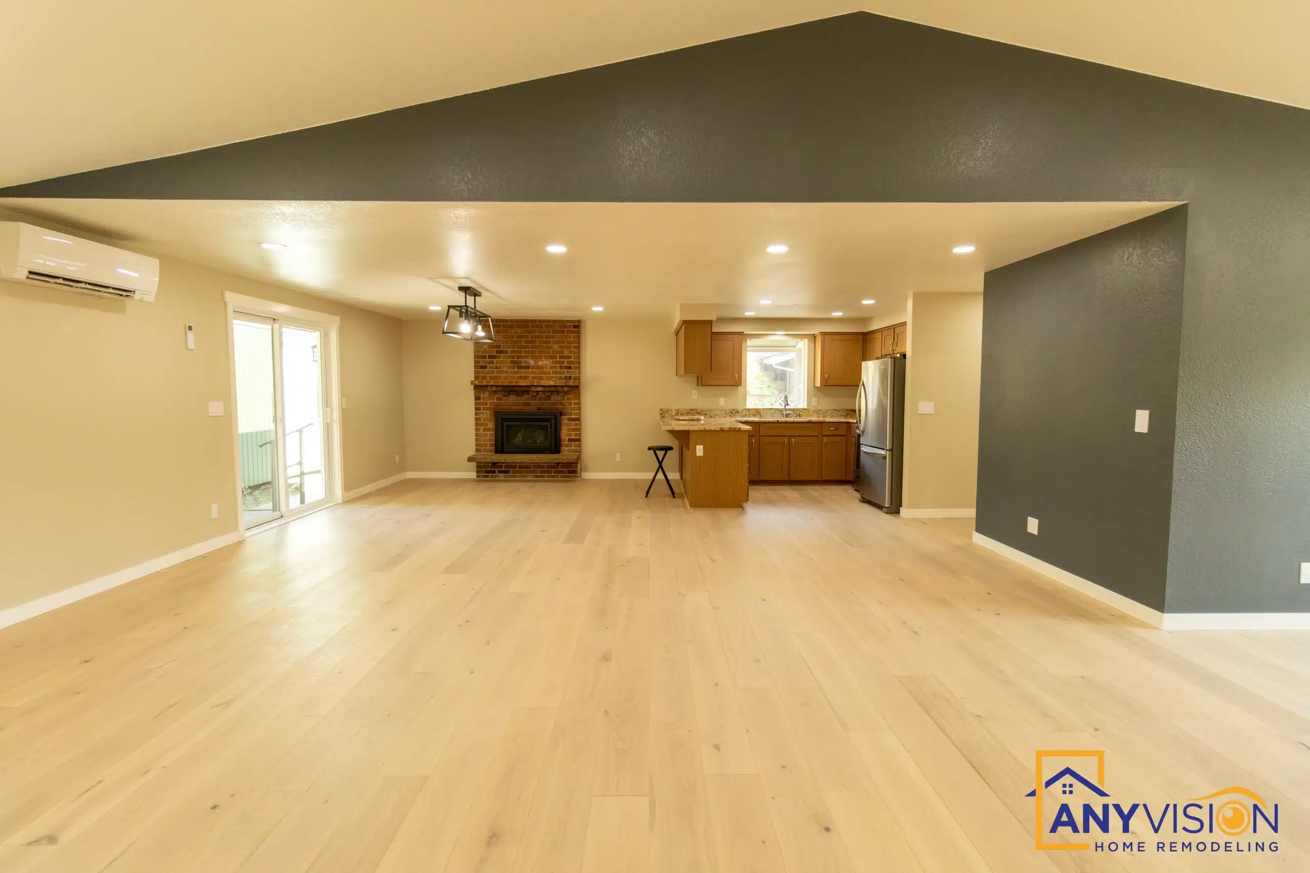 Vaulted living space with a fireplace and the dining area beyond