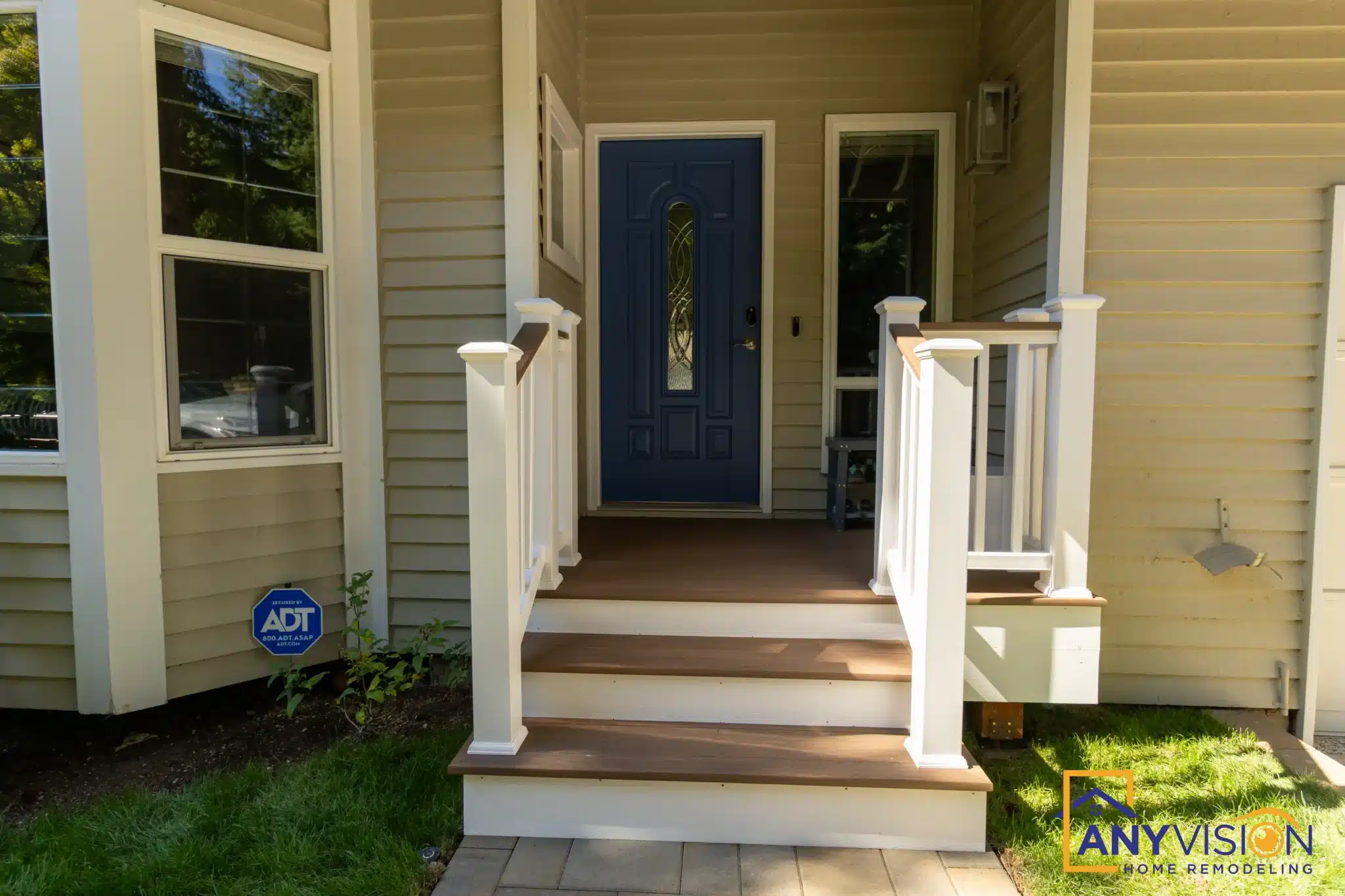 New front entry steps with white posts and railings