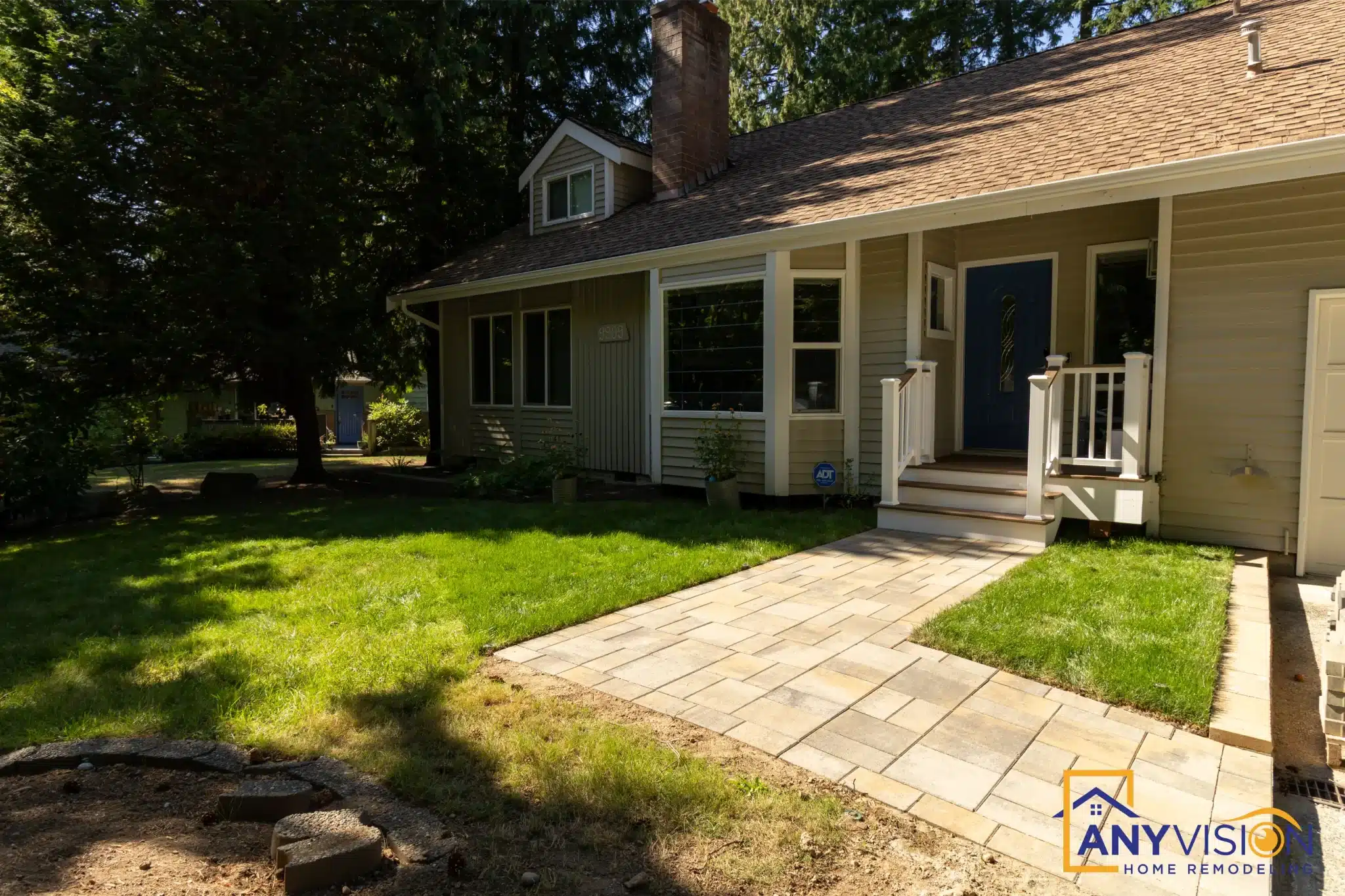 Stone walkway curving across the front lawn to the entry