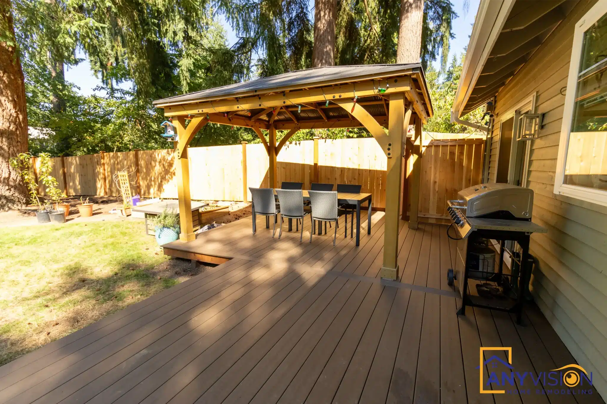 Cedar pergola over the rear deck with seating and grill beneath