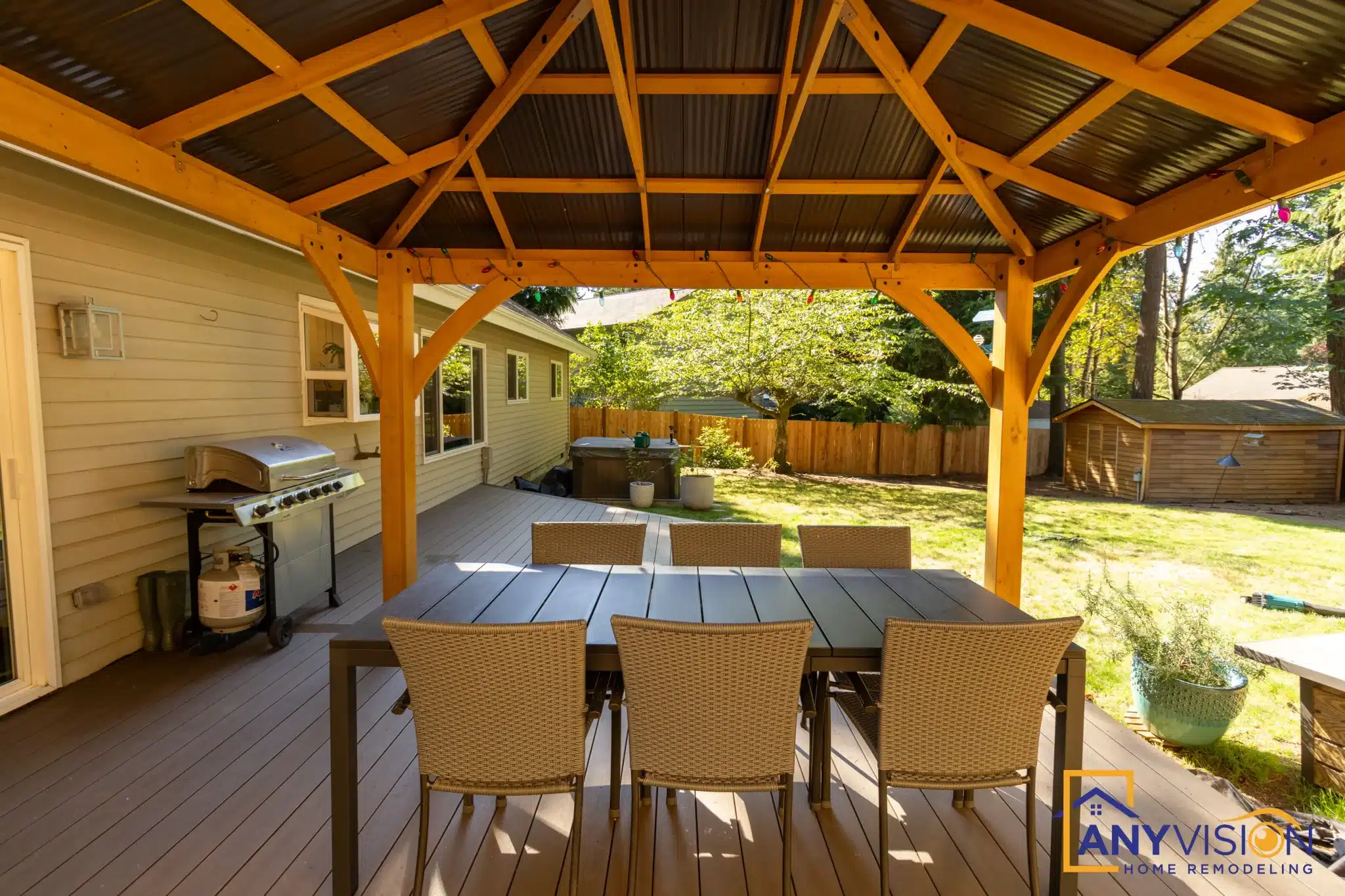 Dining table beneath a cedar pergola with radial rafter work, Education Hill Redmond