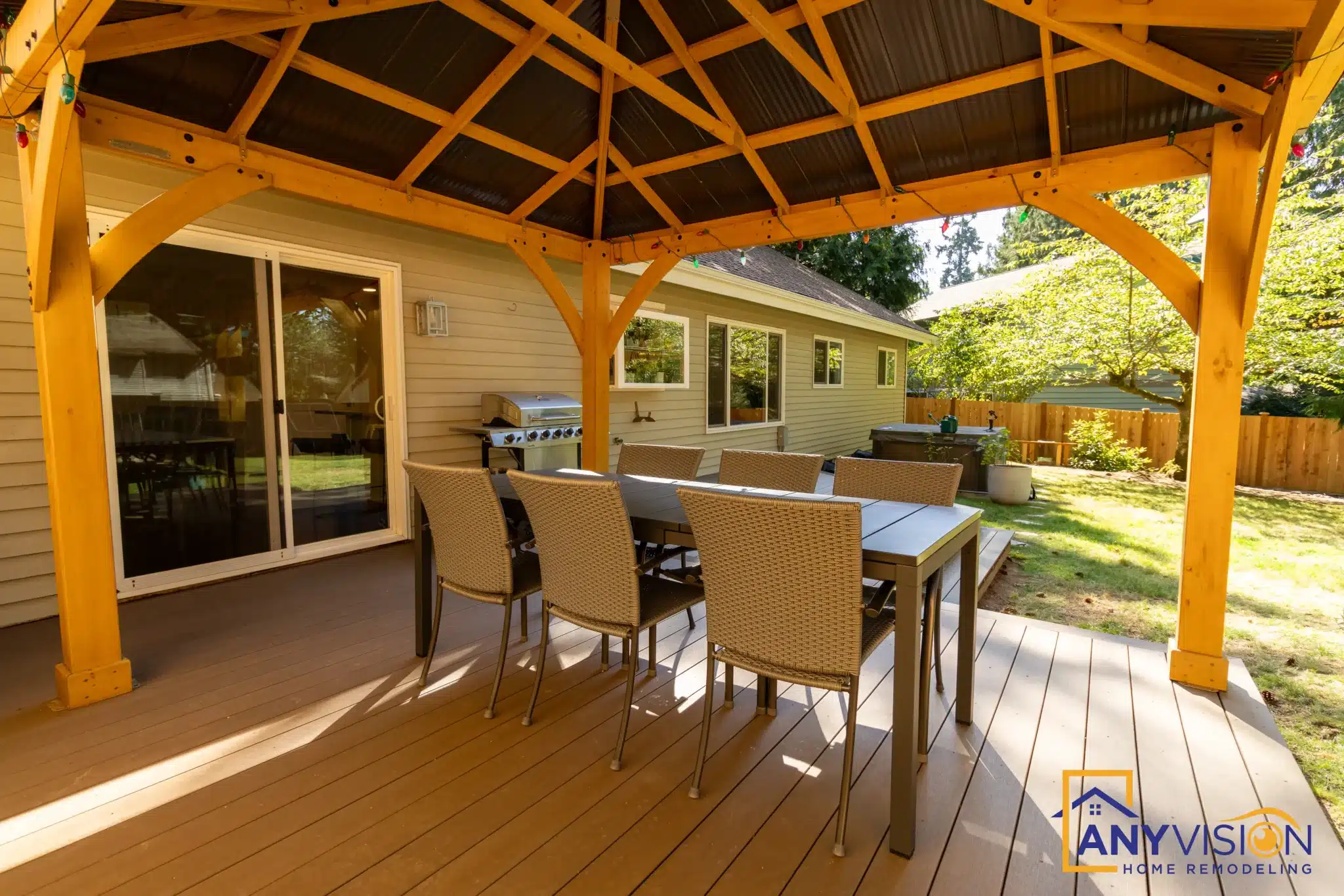 Looking out from beneath the pergola across the deck and garden