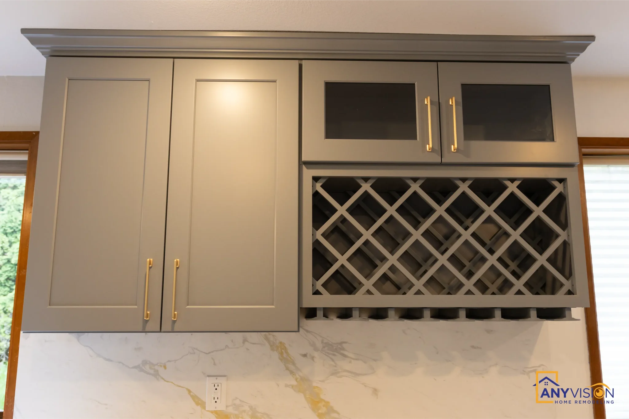 Built-in wine rack set into the upper cabinetry with glass-front doors above