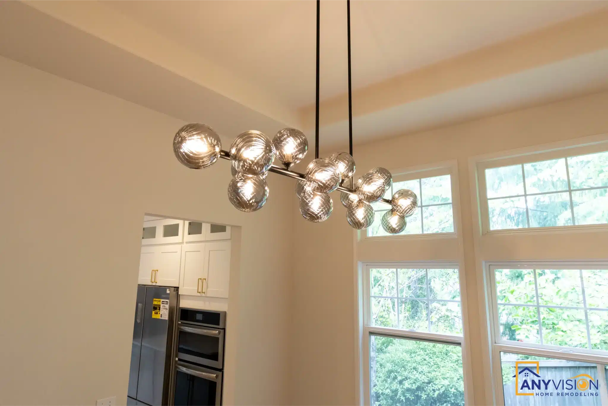 Dining area with globe chandelier beside the kitchen
