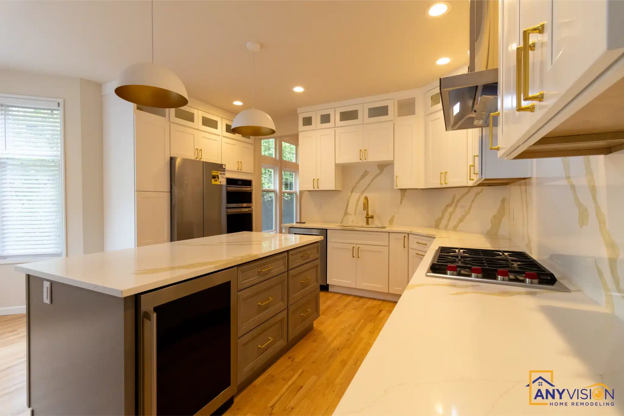 Brass chimney hood above the gas range against the slab backsplash