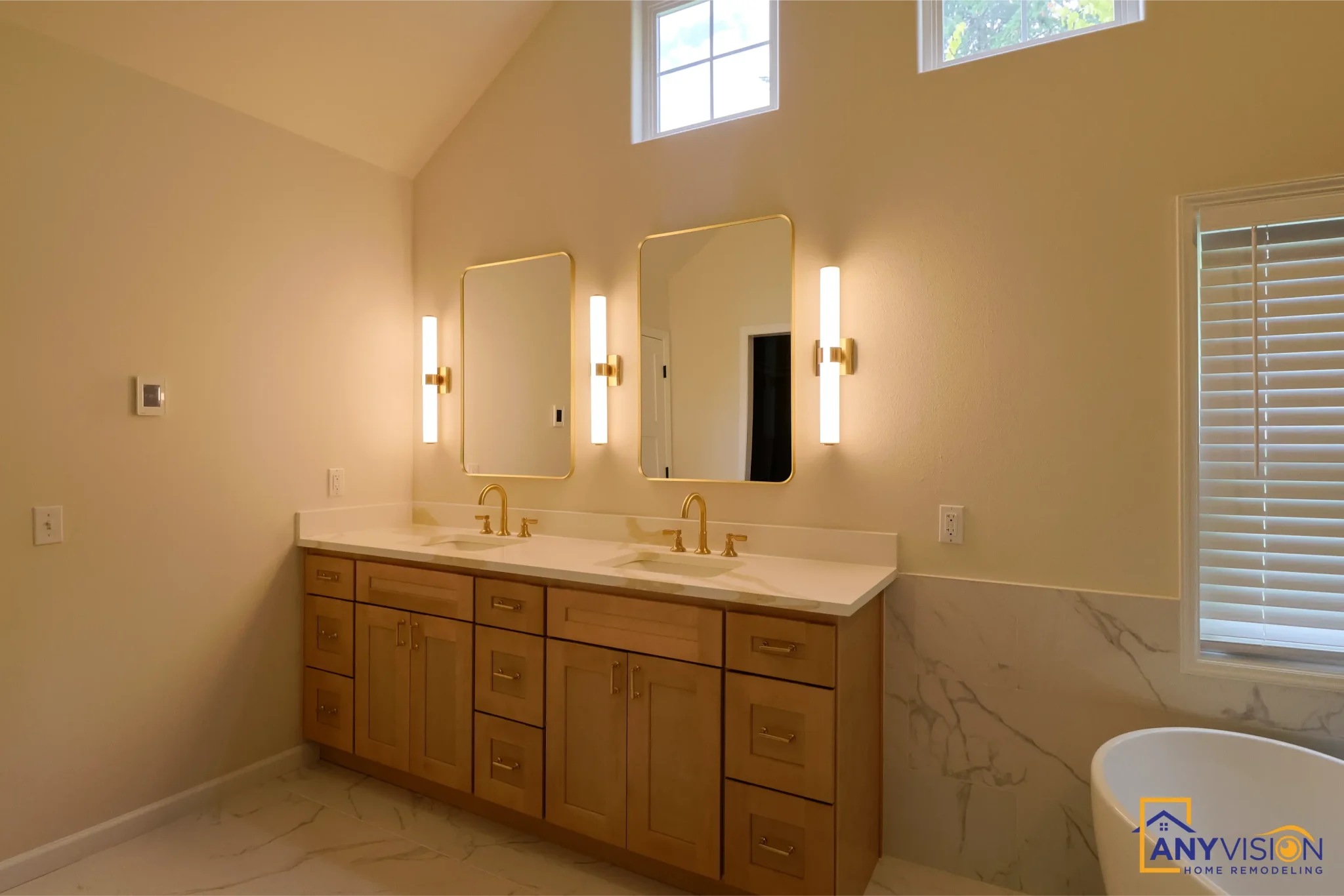 Vanity run with brass taps and wall sconces