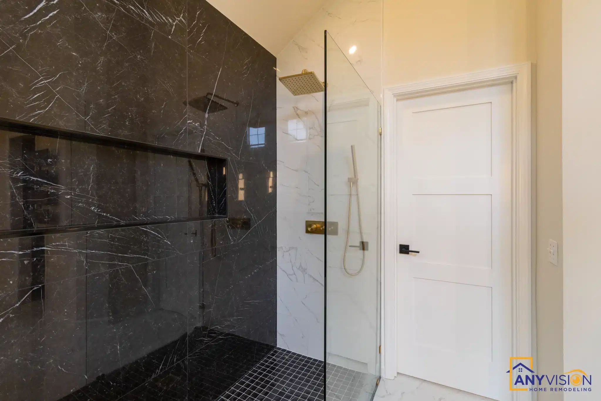 Walk-in shower with black marble slab walls and brass fixtures