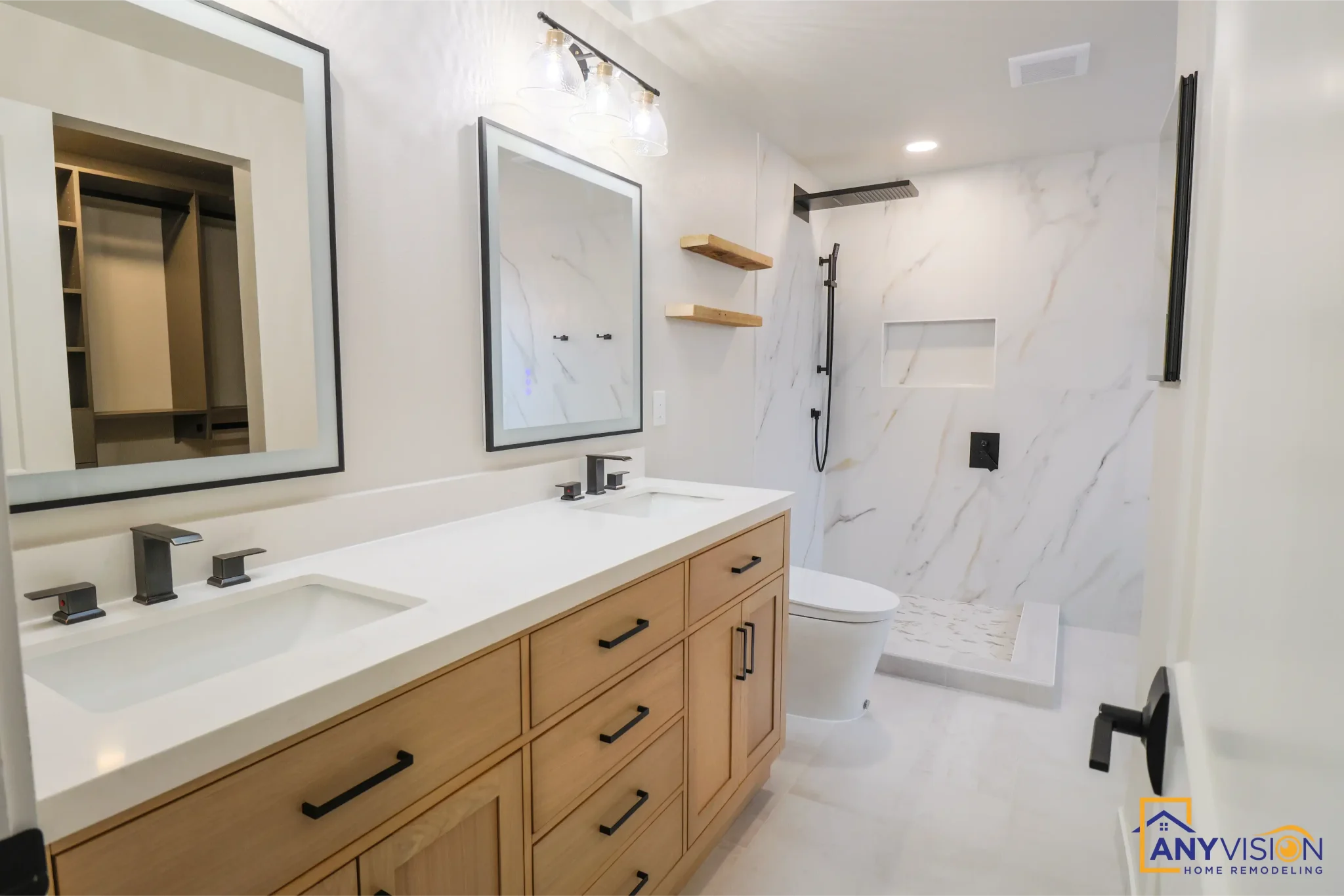 Double oak vanity with twin black-framed mirrors and the shower beyond