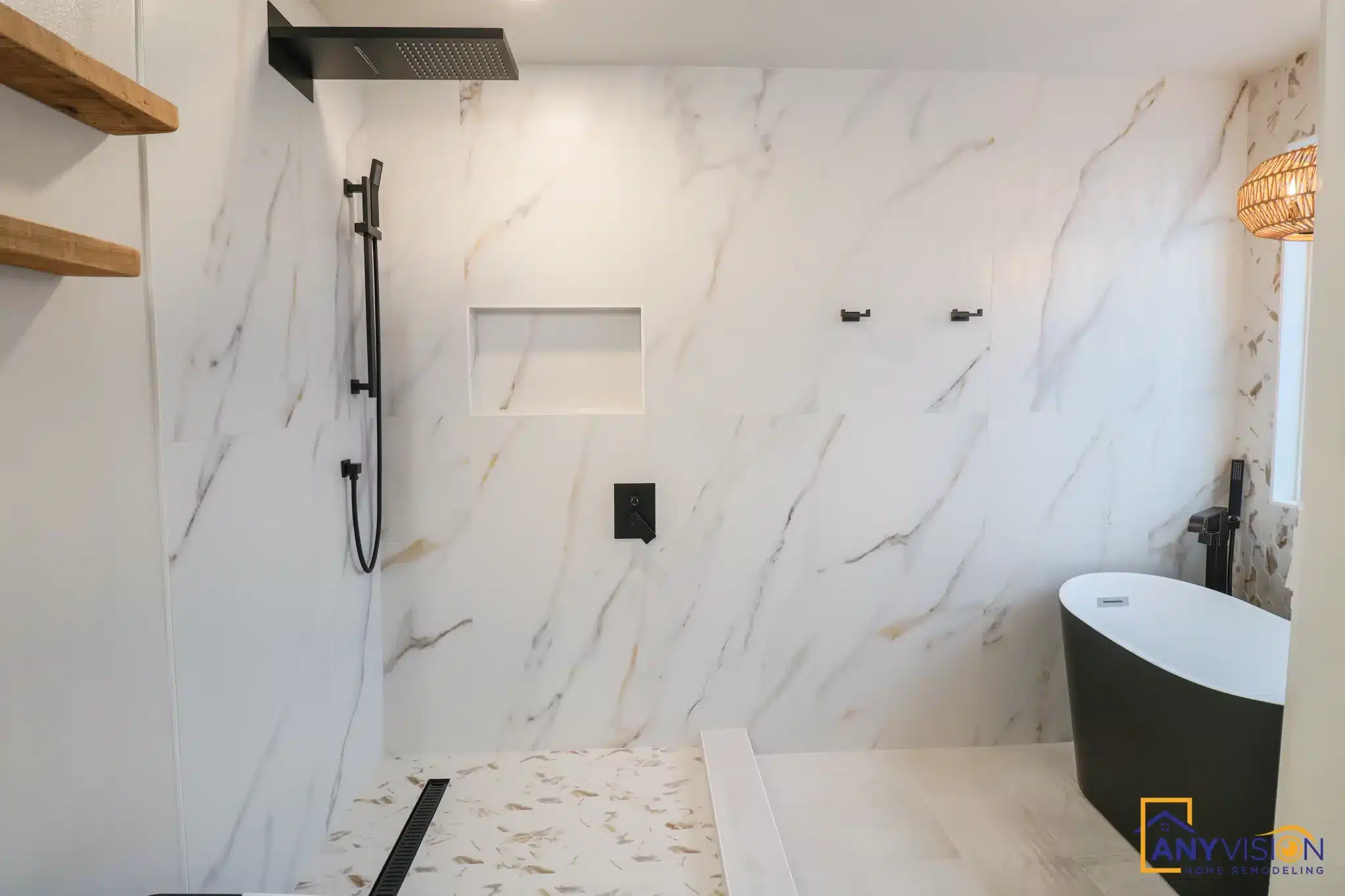 Walk-in shower and freestanding tub sharing one wet zone against marble-look slab