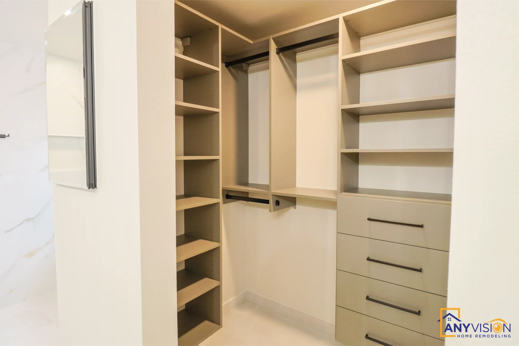 Fitted walk-in closet with open shelving and drawer banks
