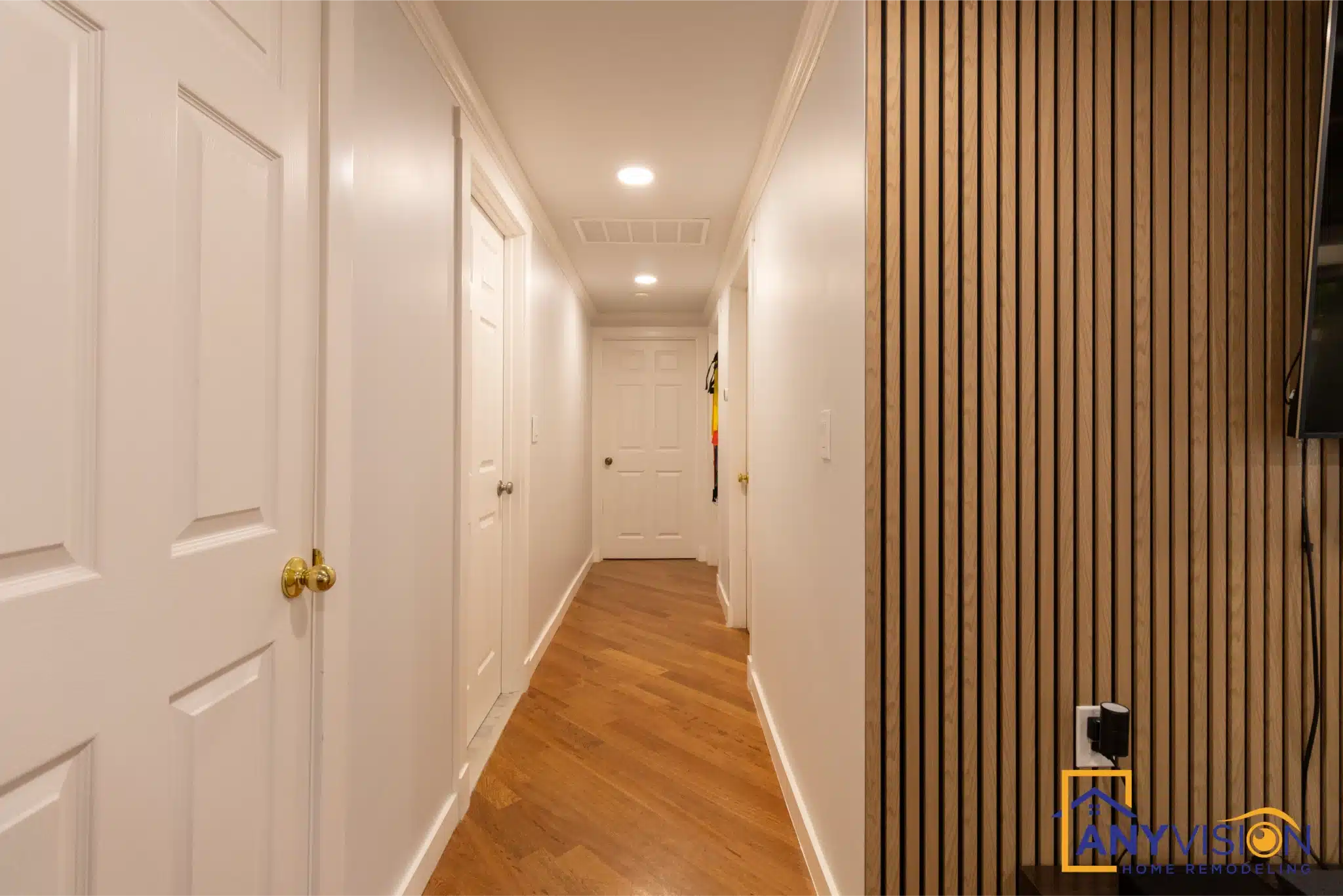 Basement hallway with timber panelling and recessed lighting