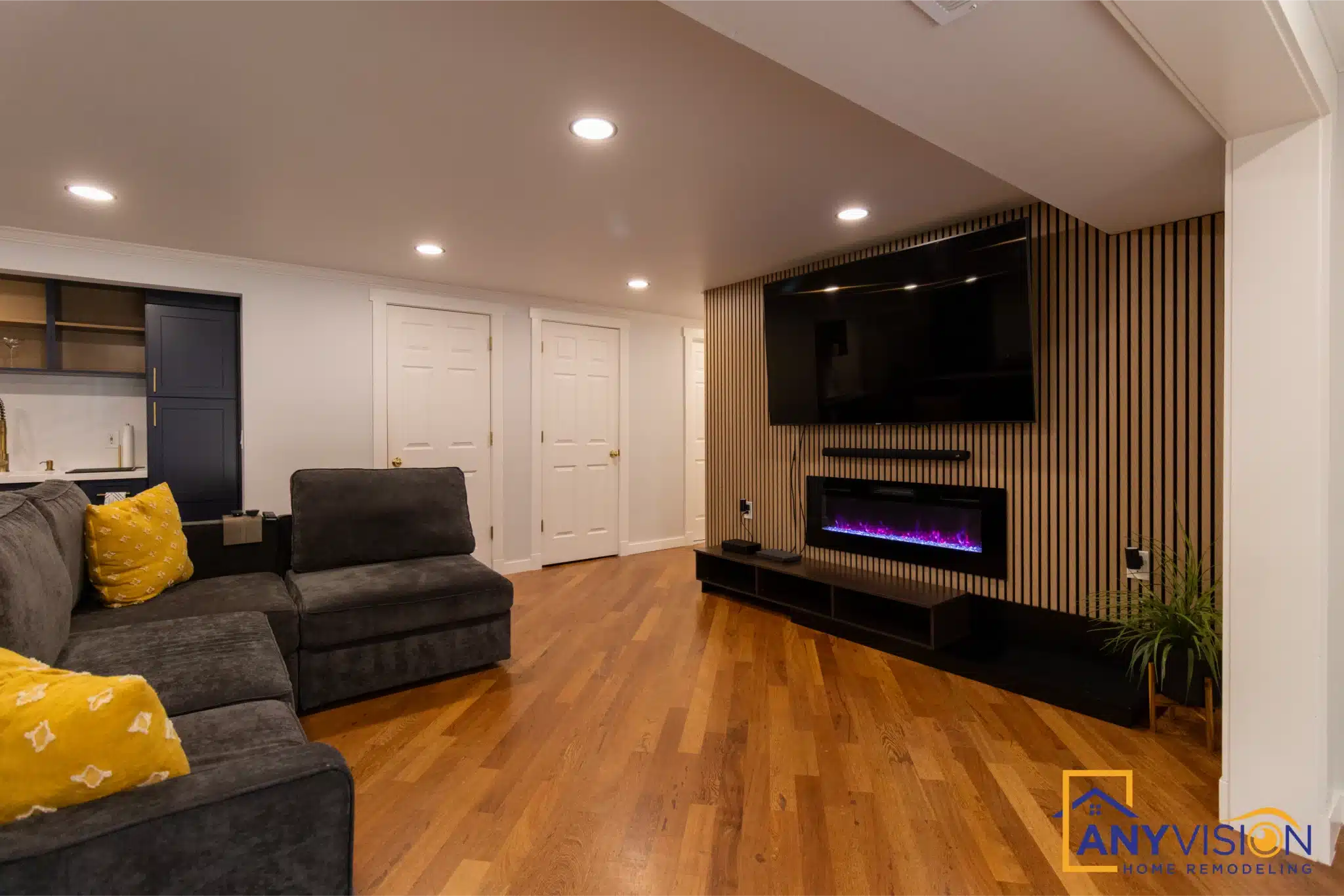 Finished basement with slatted timber wall and linear fireplace, Lake Hills Bellevue