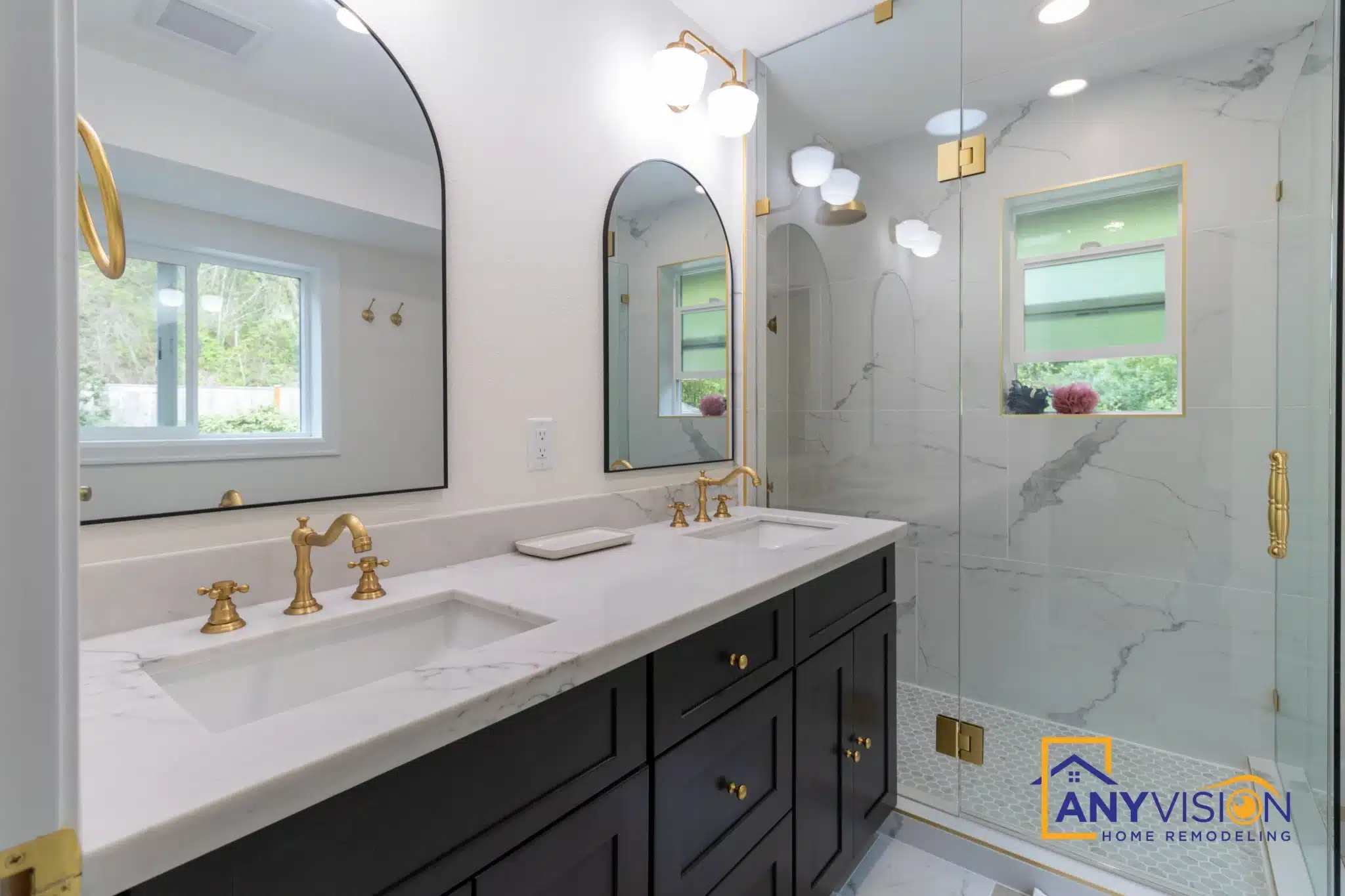 Vanity and arched mirror seen from the far end of the bathroom