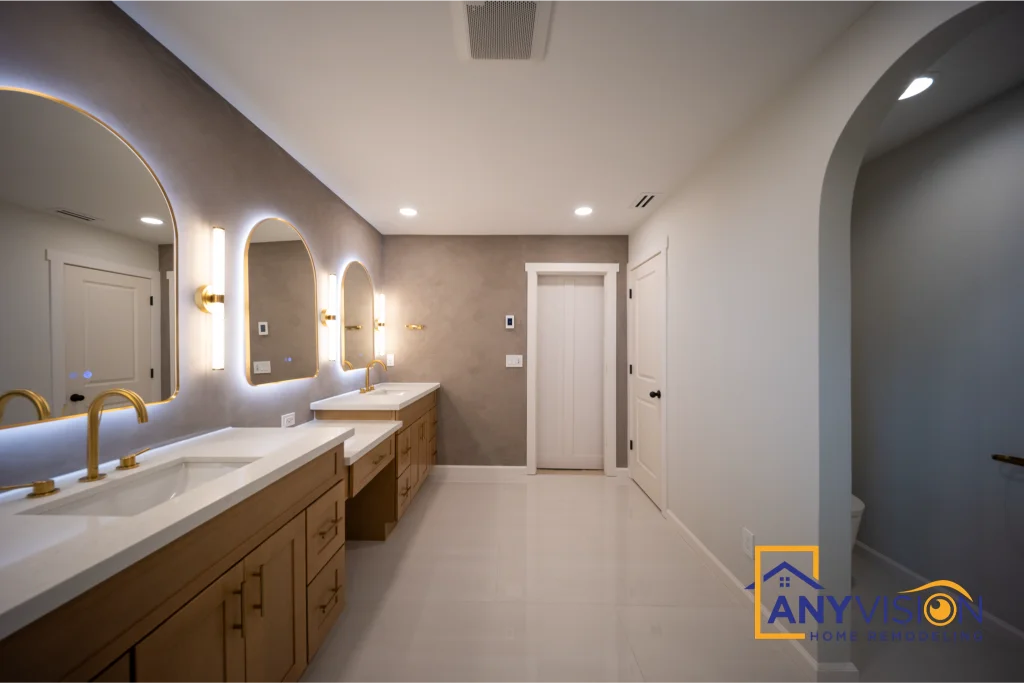 Long wood vanity with twin basins, arched mirrors and wall sconces