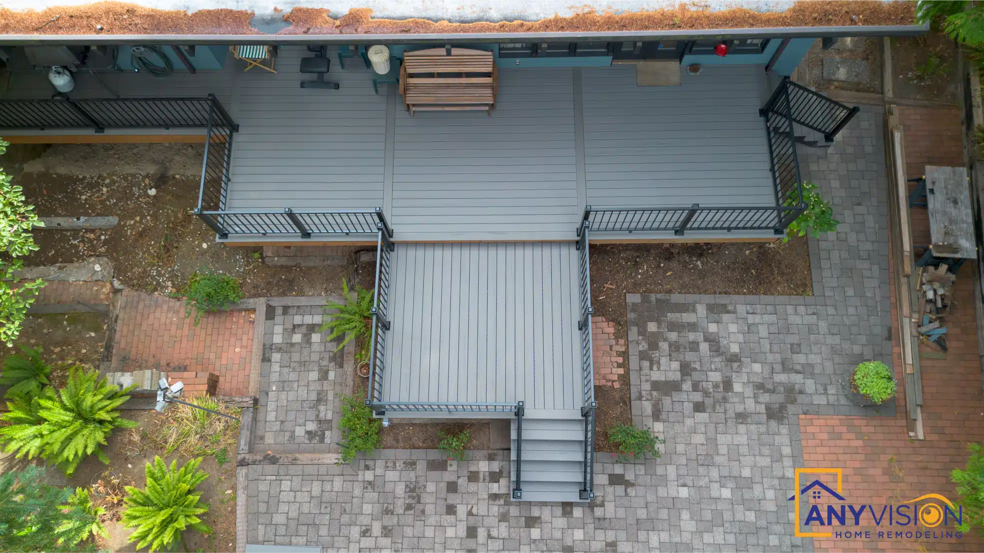 Overhead view of the covered deck, open terrace and paver patio below