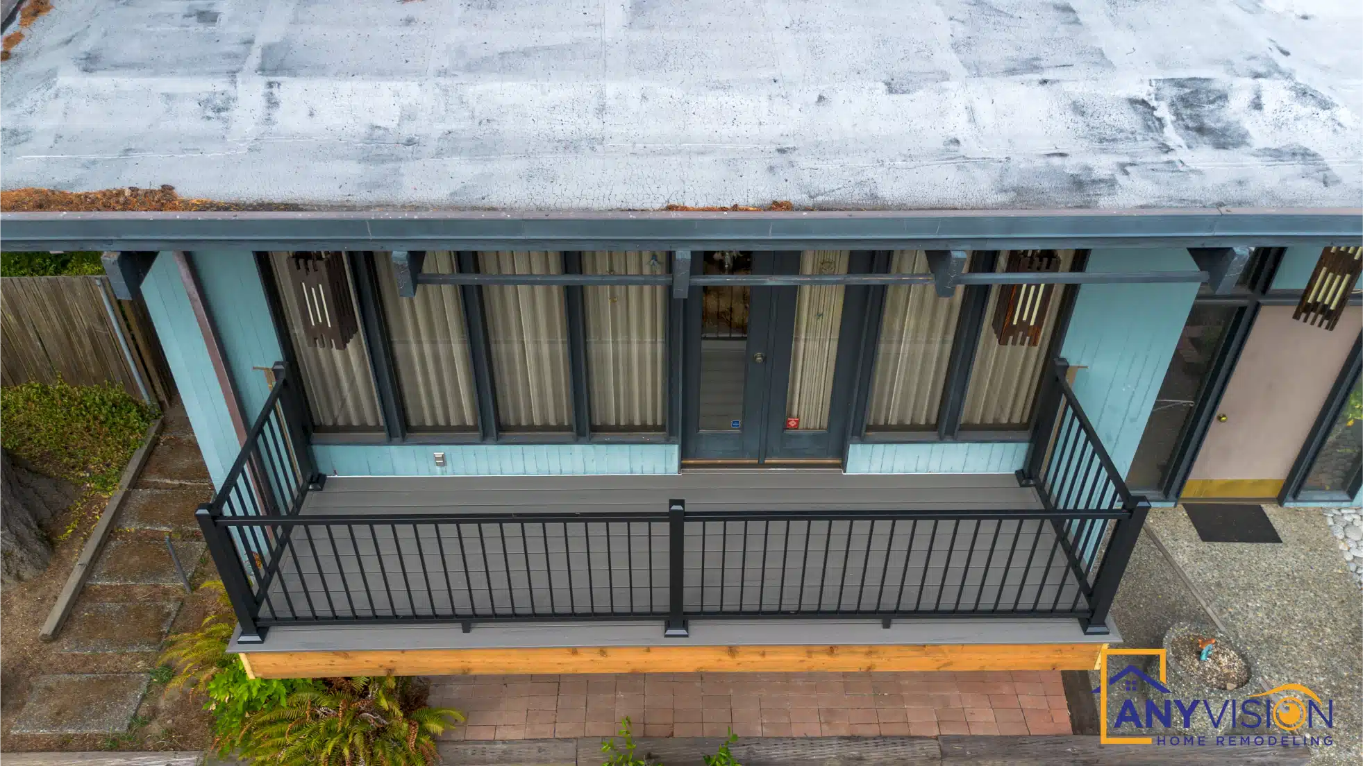Covered deck structure with a low-slope roof and vertical screening